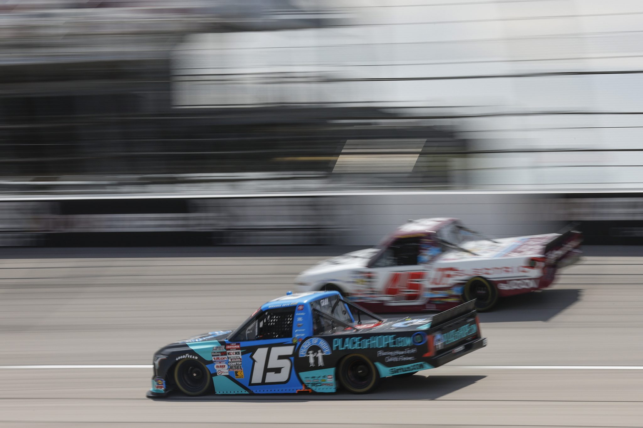 DARLINGTON, SOUTH CAROLINA - AUGUST 30: Tanner Gray, driver of the #15 Place of Hope Toyota, and Bayley Currey, driver of the #45 DQS Solutions & Staffing Chevrolet, race during the NASCAR Craftsman Truck Series Sober or Slammer 200 at Darlington Raceway on August 30, 2025 in Darlington, South Carolina. (Photo by Logan Riely/Getty Images) | Getty Images