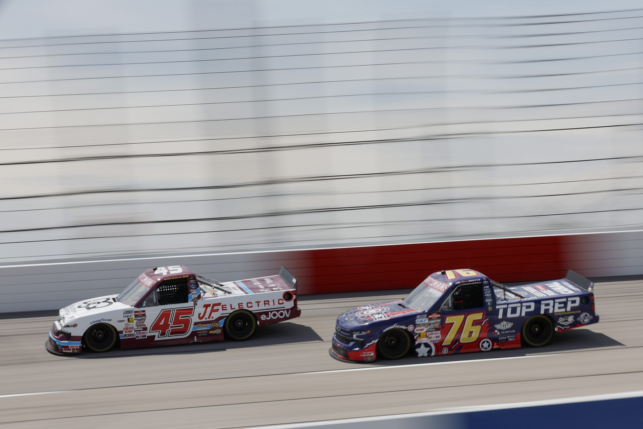 DARLINGTON, SOUTH CAROLINA - AUGUST 30: Bayley Currey, driver of the #45 DQS Solutions & Staffing Chevrolet, and Spencer Boyd, driver of the #76 Top Rep Training Chevrolet, race during the NASCAR Craftsman Truck Series Sober or Slammer 200 at Darlington Raceway on August 30, 2025 in Darlington, South Carolina. (Photo by Logan Riely/Getty Images) | Getty Images