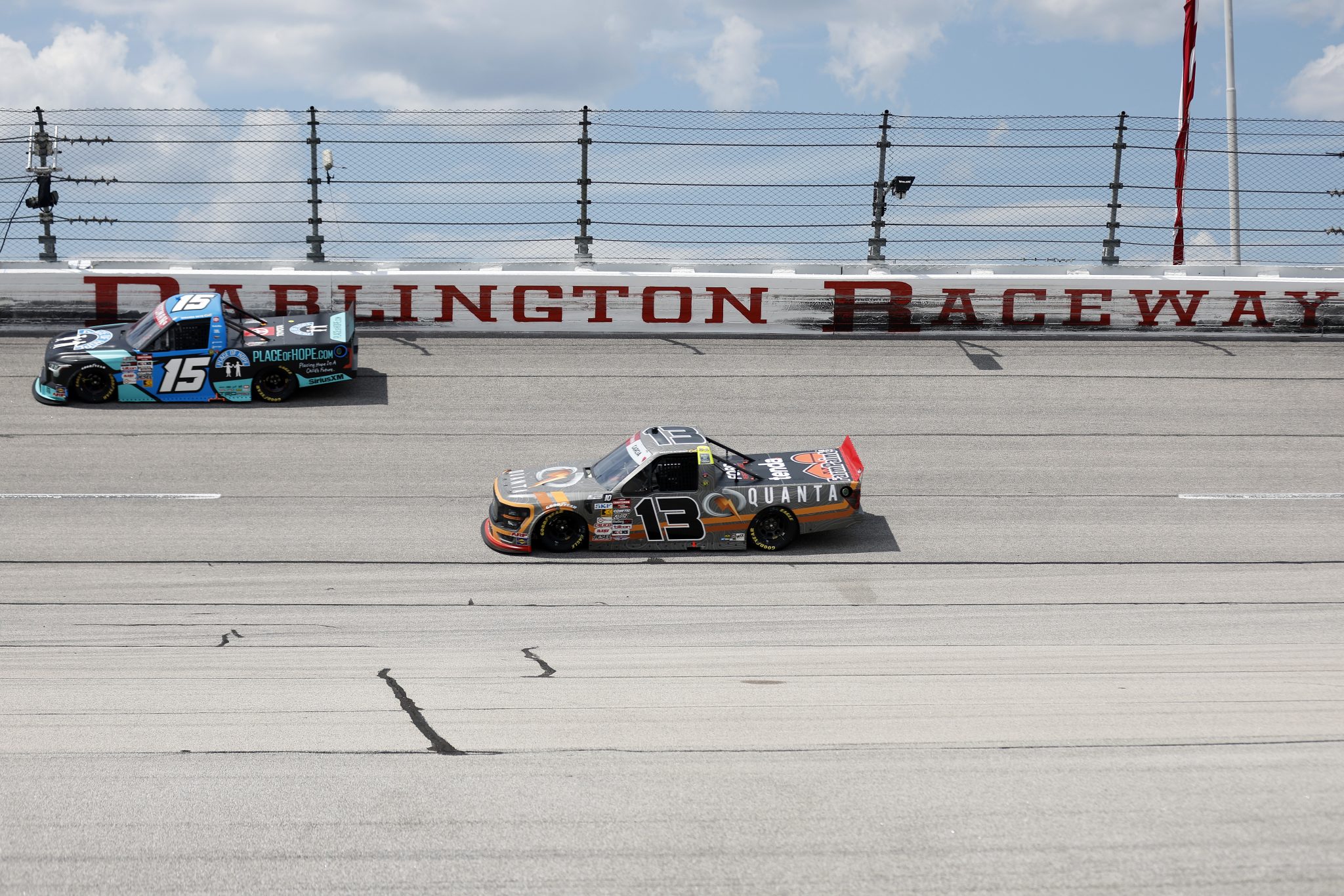 DARLINGTON, SOUTH CAROLINA - AUGUST 30: Jake Garcia, driver of the #13 Quanta Services Ford, and Tanner Gray, driver of the #15 Place of Hope Toyota, race during the NASCAR Craftsman Truck Series Sober or Slammer 200 at Darlington Raceway on August 30, 2025 in Darlington, South Carolina. (Photo by Logan Riely/Getty Images) | Getty Images