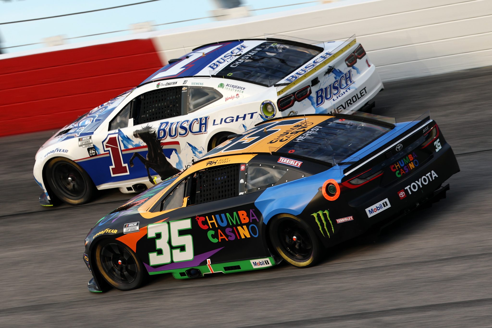 DARLINGTON, SOUTH CAROLINA - AUGUST 31: Riley Herbst, driver of the #35 Chumba Casino Toyota, and Ross Chastain, driver of the #1 Busch Light Retro Chevrolet, race during the NASCAR Cup Series Cook Out Southern 500 at Darlington Raceway on August 31, 2025 in Darlington, South Carolina. (Photo by Jared C. Tilton/Getty Images) | Getty Images
