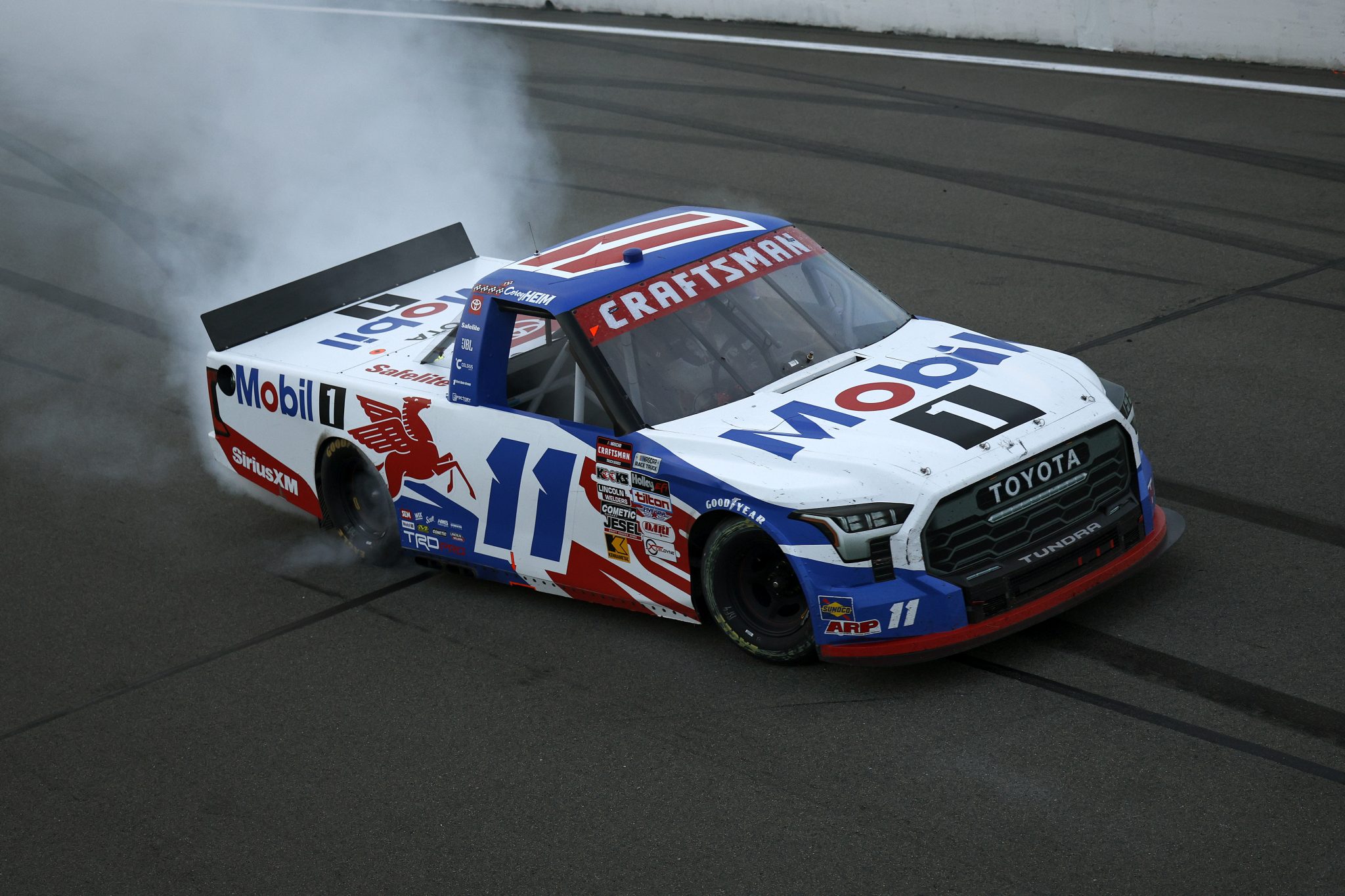 WATKINS GLEN, NEW YORK - AUGUST 08: Corey Heim, driver of the #11 Mobil 1 Toyota, celebrates with a burnout after winning the NASCAR Craftsman Truck Series Mission 176 at The Glen at Watkins Glen International on August 08, 2025 in Watkins Glen, New York. (Photo by Sean Gardner/Getty Images) | Getty Images