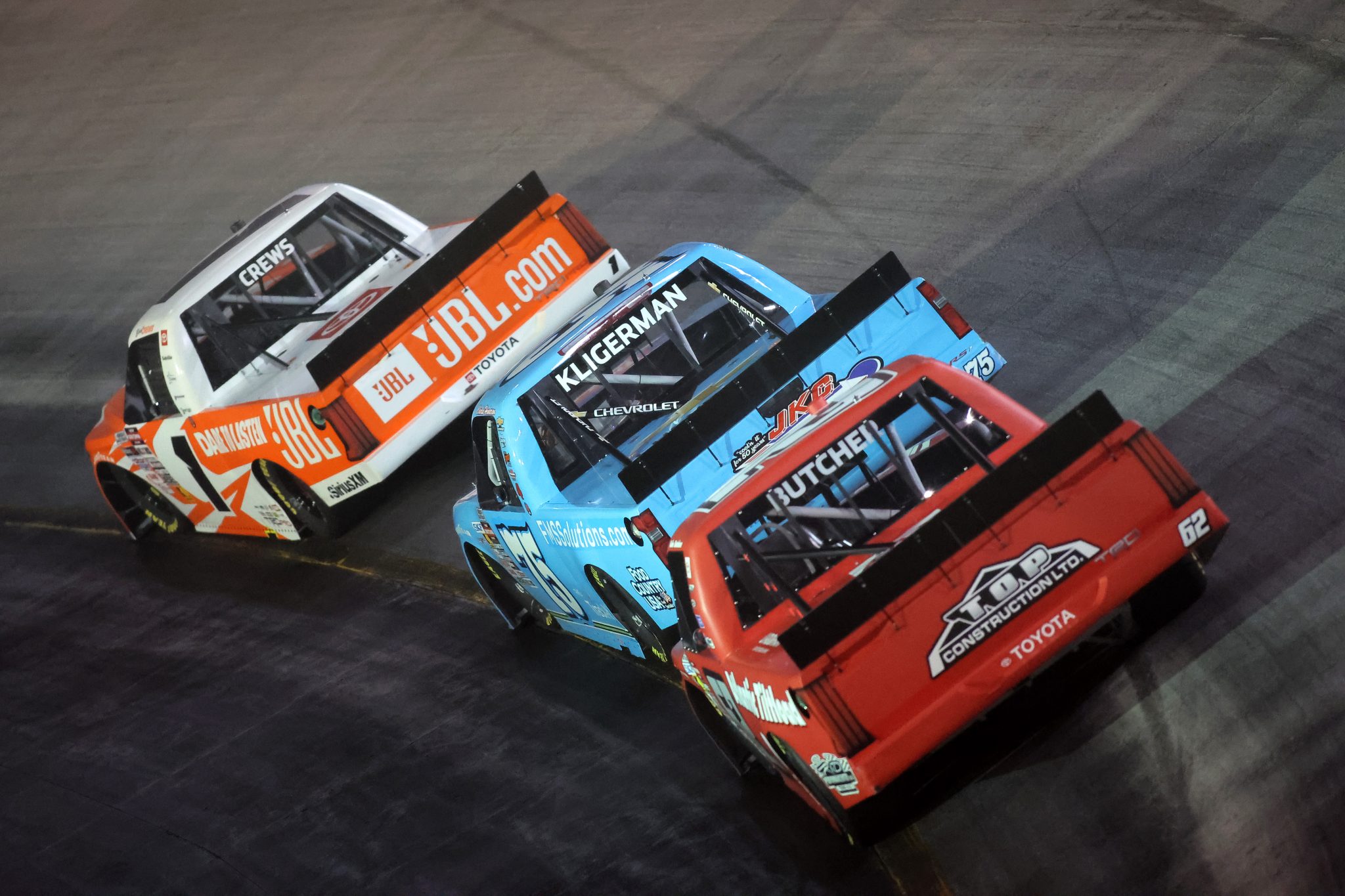 BRISTOL, TENNESSEE - SEPTEMBER 11: Brent Crews, driver of the #1 JBL Toyota, Parker Kligerman, driver of the #75 FMS Solutions Chevrolet, and Cole Butcher, driver of the #62 Atlantic Tiltload Toyota, race during the NASCAR Craftsman Truck Series UNOH 200 presented by Ohio Logistics at Bristol Motor Speedway on September 11, 2025 in Bristol, Tennessee. (Photo by Jonathan Bachman/Getty Images) | Getty Images