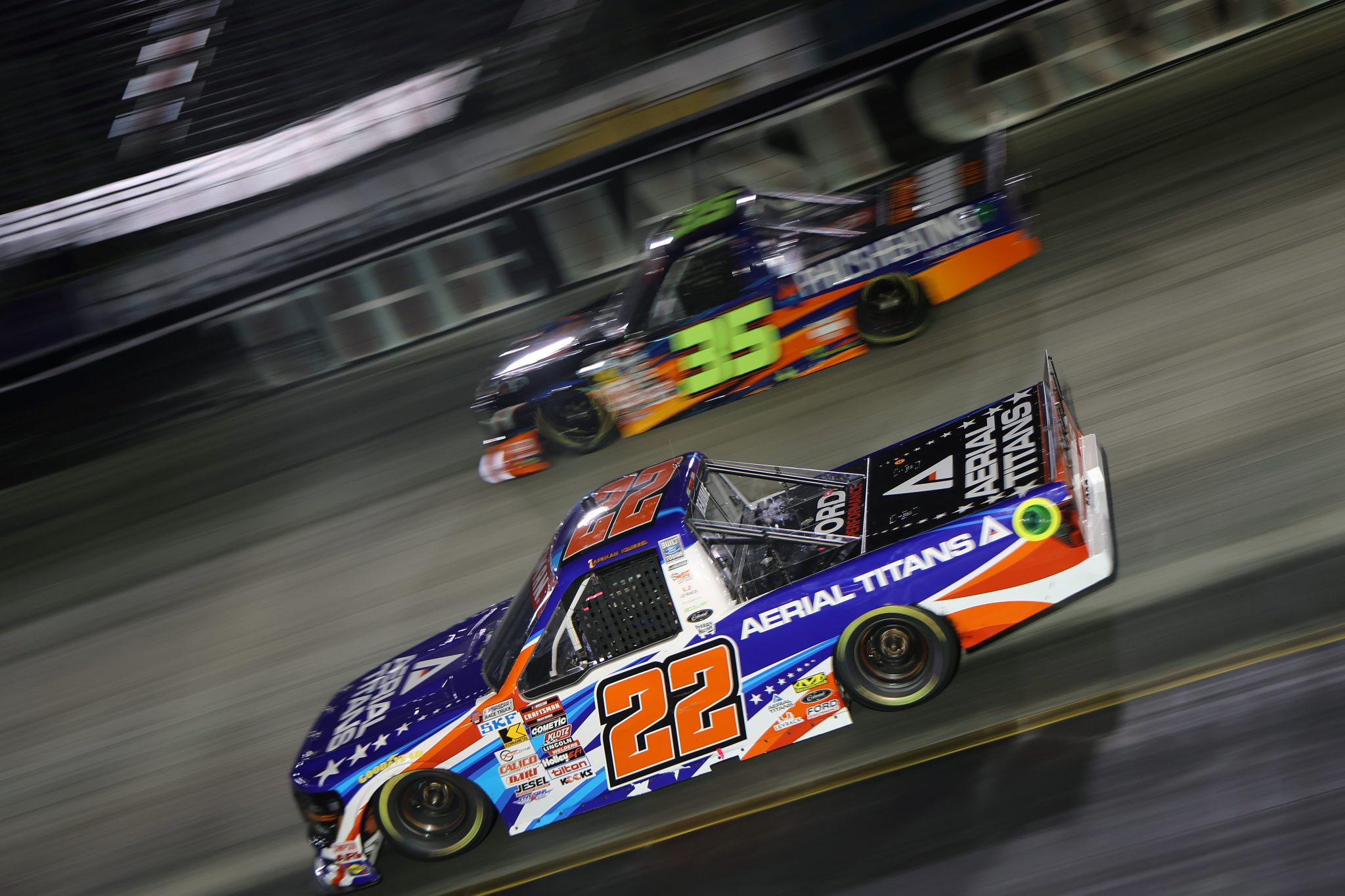 BRISTOL, TENNESSEE - SEPTEMBER 11: Josh Reaume, driver of the #22 Aerial Titans Ford, and Greg Van Alst, driver of the #35 Phil's Heating & Air Toyota, race during the NASCAR Craftsman Truck Series UNOH 200 presented by Ohio Logistics at Bristol Motor Speedway on September 11, 2025 in Bristol, Tennessee. (Photo by Jonathan Bachman/Getty Images) | Getty Images