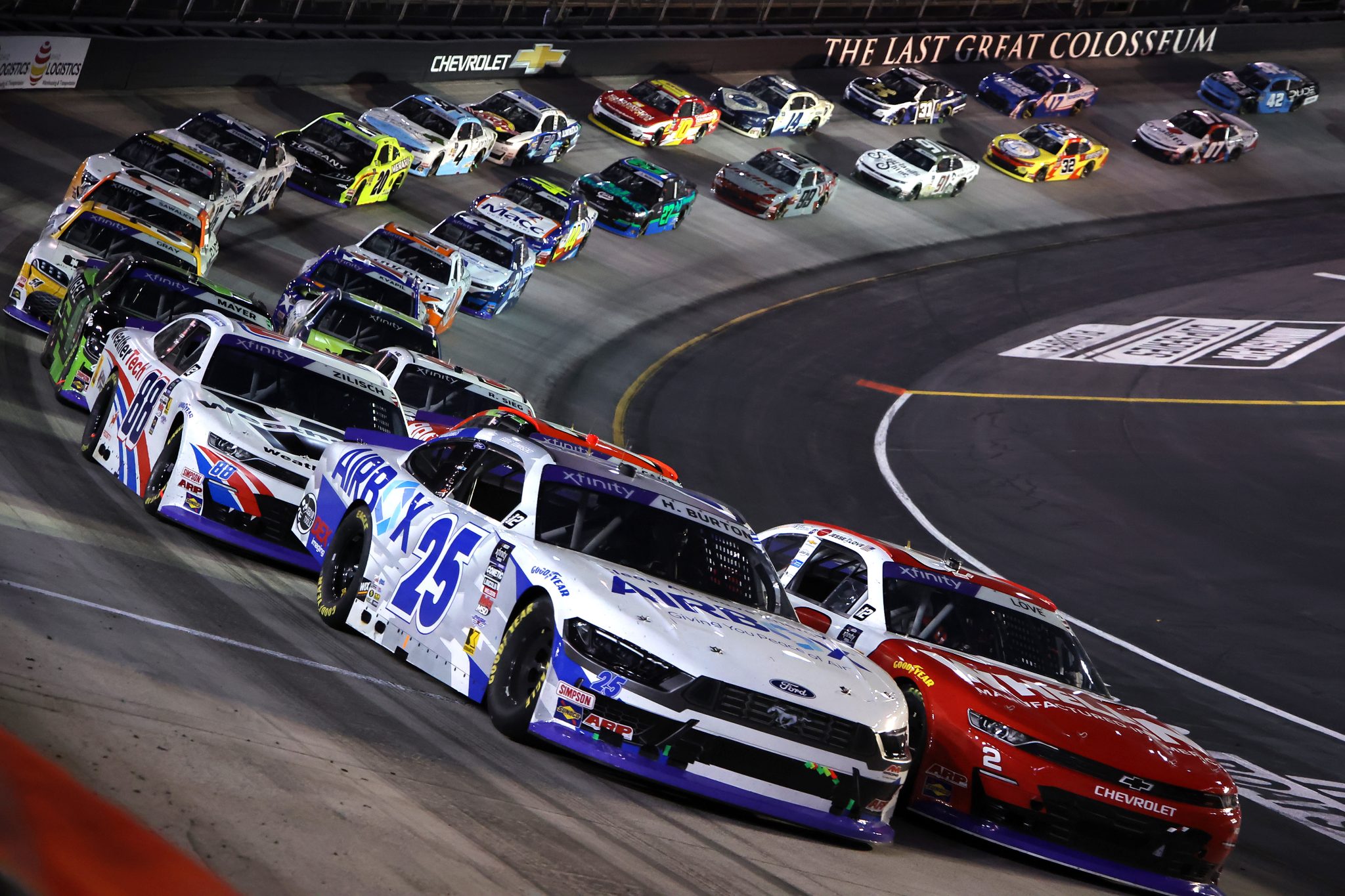 BRISTOL, TENNESSEE - SEPTEMBER 12: Jesse Love, driver of the #2 Whelen Chevrolet, and Harrison Burton, driver of the #25 AirBox Ford, race during the NASCAR Xfinity Series Food City 300 at Bristol Motor Speedway on September 12, 2025 in Bristol, Tennessee. (Photo by Jonathan Bachman/Getty Images) | Getty Images