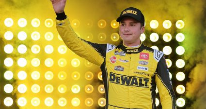 BRISTOL, TENNESSEE - SEPTEMBER 13: Christopher Bell, driver of the #20 DEWALT Toyota, waves to fans as he walks onstage during driver intros prior to the NASCAR Cup Series Bass Pro Shops Night Race at Bristol Motor Speedway on September 13, 2025 in Bristol, Tennessee. (Photo by Jonathan Bachman/Getty Images) | Getty Images