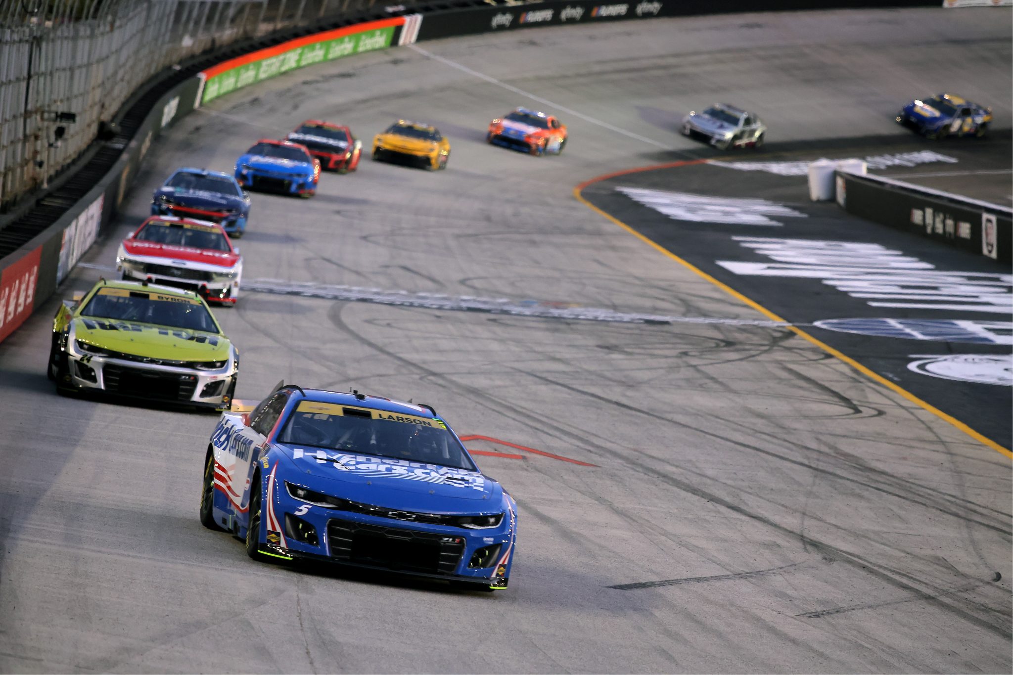 BRISTOL, TENNESSEE - SEPTEMBER 13: Kyle Larson, driver of the #5 HendrickCars.com Chevrolet, and William Byron, driver of the #24 Raptor Chevrolet, race during the NASCAR Cup Series Bass Pro Shops Night Race at Bristol Motor Speedway on September 13, 2025 in Bristol, Tennessee. (Photo by Jonathan Bachman/Getty Images) | Getty Images