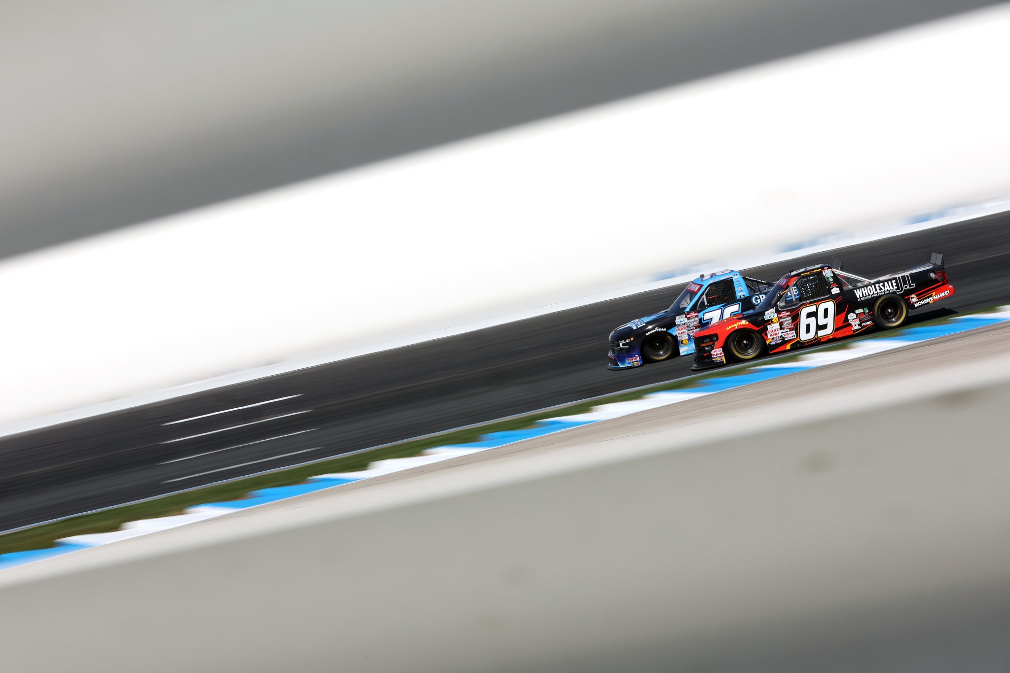 LOUDON, NEW HAMPSHIRE - SEPTEMBER 20: Derek White, driver of the #69 Wholesale JL Ford, and Spencer Boyd, driver of the #76 Granite State De-Icing Supply Chevrolet, race during the NASCAR Craftsman Truck Series Team EJP 175 at New Hampshire Motor Speedway on September 20, 2025 in Loudon, New Hampshire. (Photo by Meg Oliphant/Getty Images) | Getty Images