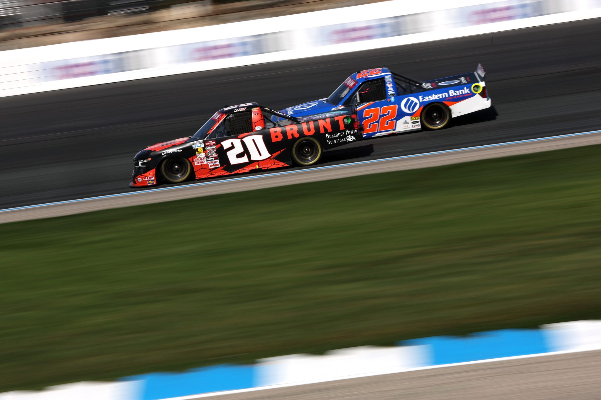 LOUDON, NEW HAMPSHIRE - SEPTEMBER 20: Mason Massey, driver of the #20 BRUNT Chevrolet, and Blake Lothian, driver of the #22 Eastern Bank Ford, race during the NASCAR Craftsman Truck Series Team EJP 175 at New Hampshire Motor Speedway on September 20, 2025 in Loudon, New Hampshire. (Photo by Meg Oliphant/Getty Images) | Getty Images