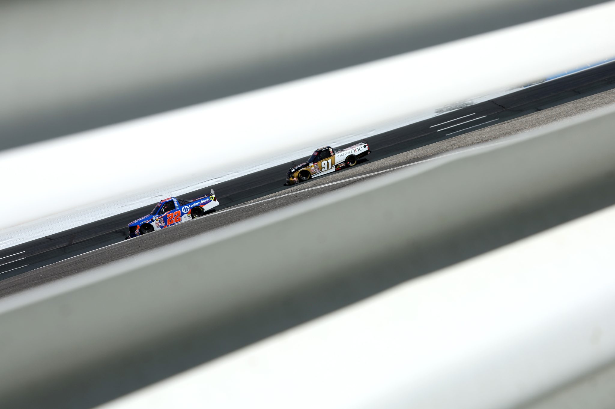 LOUDON, NEW HAMPSHIRE - SEPTEMBER 20: Blake Lothian, driver of the #22 Eastern Bank Ford, and Jack Wood, driver of the #91 Adaptive One Calipers Chevrolet, race during the NASCAR Craftsman Truck Series Team EJP 175 at New Hampshire Motor Speedway on September 20, 2025 in Loudon, New Hampshire. (Photo by Meg Oliphant/Getty Images) | Getty Images