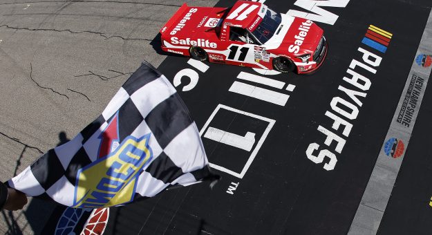 LOUDON, NEW HAMPSHIRE - SEPTEMBER 20: Corey Heim, driver of the #11 Safelite Toyota, takes the checkered flag to win the NASCAR Craftsman Truck Series Team EJP 175 at New Hampshire Motor Speedway on September 20, 2025 in Loudon, New Hampshire. (Photo by Sean Gardner/Getty Images) | Getty Images