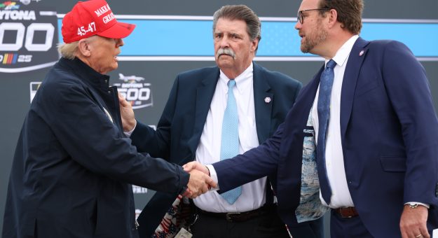 DAYTONA BEACH, FLORIDA - FEBRUARY 16: U.S. President Donald Trump is greeted by NASCAR Senior Vice President Chip Wile on the grid prior to the NASCAR Cup Series Daytona 500 at Daytona International Speedway on February 16, 2025 in Daytona Beach, Florida. (Photo by Chris Graythen/Getty Images) | Getty Images