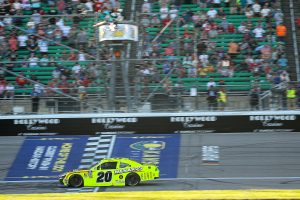 KANSAS CITY, KANSAS - SEPTEMBER 27: Brandon Jones, driver of the #20 Menards/Spectracide Toyota, takes the checkered flag to win the NASCAR Xfinity Series Kansas Lottery 300 at Kansas Speedway on September 27, 2025 in Kansas City, Kansas. (Photo by Chris Graythen/Getty Images) | Getty Images