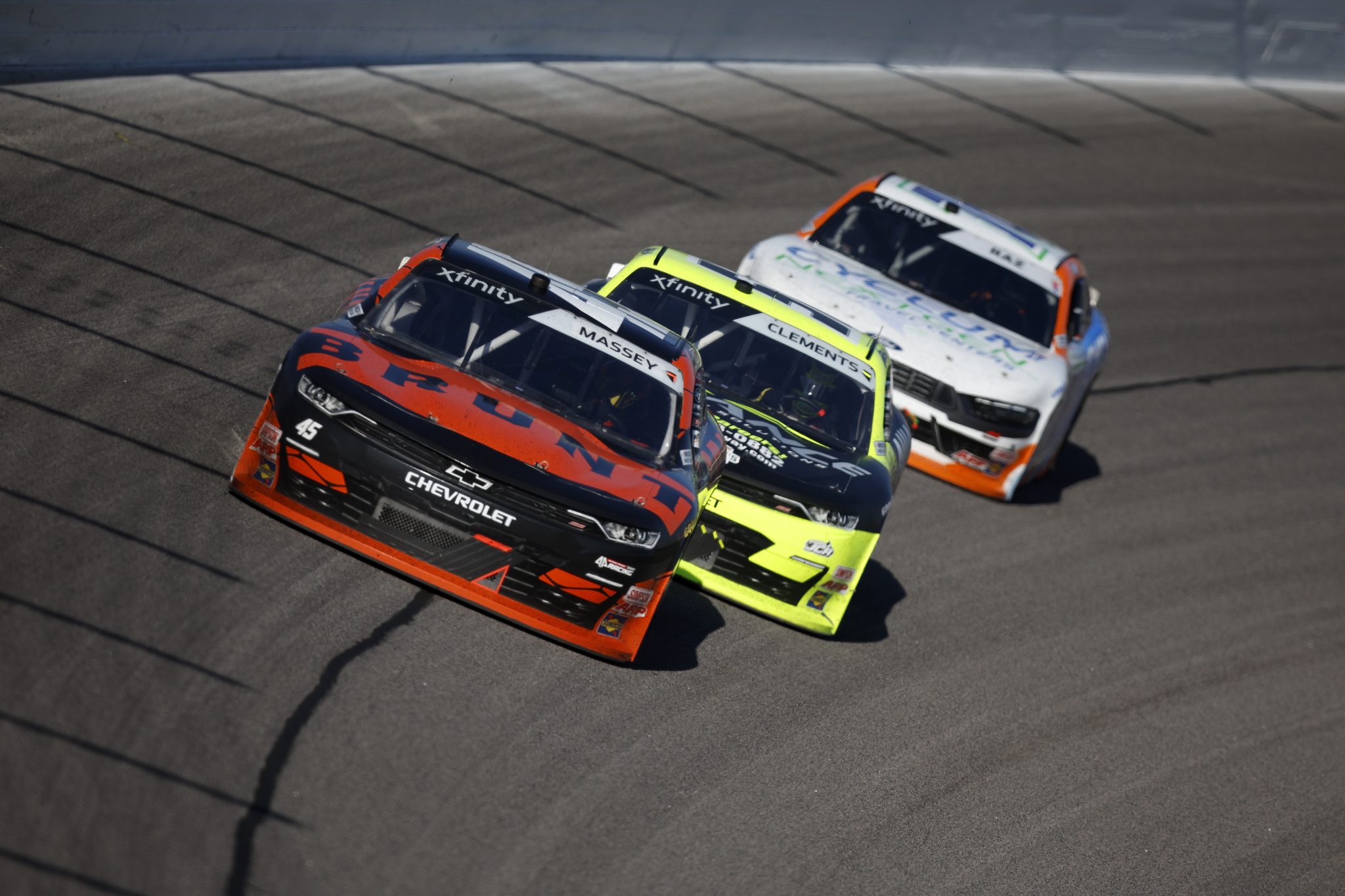 KANSAS CITY, KANSAS - SEPTEMBER 27: Mason Massey, driver of the #45 Brunt Chevrolet, Jeremy Clements, driver of the #51 Alliance Driveway Solutions Chevrolet, and Kole Raz, driver of the #76 Cyclum Next Gen Travel Centers Ford, race during the NASCAR Xfinity Series Kansas Lottery 300 at Kansas Speedway on September 27, 2025 in Kansas City, Kansas. (Photo by Sean Gardner/Getty Images) | Getty Images