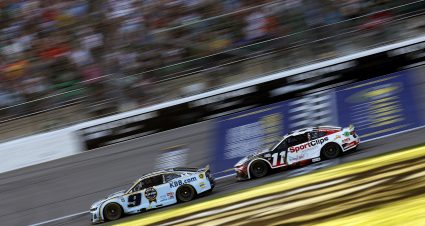 KANSAS CITY, KANSAS - SEPTEMBER 28: Chase Elliott, driver of the #9 Kelley Blue Book Chevrolet, and Denny Hamlin, driver of the #11 Sport Clips Haircuts Toyota, race during the NASCAR Cup Series Hollywood Casino 400 Presented by ESPN BET at Kansas Speedway on September 28, 2025 in Kansas City, Kansas. (Photo by Sean Gardner/Getty Images) | Getty Images