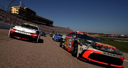 KANSAS CITY, KANSAS - SEPTEMBER 28: Chase Briscoe, driver of the #19 Bass Pro Shops Toyota, and Denny Hamlin, driver of the #11 Sport Clips Haircuts Toyota, lead the field on a pace lap prior to the NASCAR Cup Series Hollywood Casino 400 Presented by ESPN BET at Kansas Speedway on September 28, 2025 in Kansas City, Kansas. (Photo by Sean Gardner/Getty Images) | Getty Images