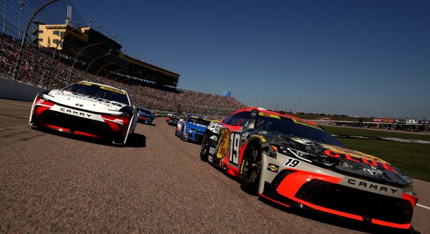 KANSAS CITY, KANSAS - SEPTEMBER 28: Chase Briscoe, driver of the #19 Bass Pro Shops Toyota, and Denny Hamlin, driver of the #11 Sport Clips Haircuts Toyota, lead the field on a pace lap prior to the NASCAR Cup Series Hollywood Casino 400 Presented by ESPN BET at Kansas Speedway on September 28, 2025 in Kansas City, Kansas. (Photo by Sean Gardner/Getty Images) | Getty Images