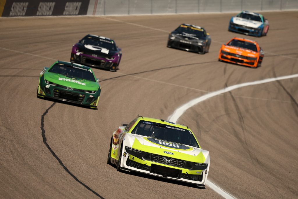 KANSAS CITY, KANSAS - SEPTEMBER 28: Noah Gragson, driver of the #4 Beef A Roo Ford, and Ricky Stenhouse Jr., driver of the #47 Ram Self Storage Chevrolet, race during the NASCAR Cup Series Hollywood Casino 400 Presented by ESPN BET at Kansas Speedway on September 28, 2025 in Kansas City, Kansas. (Photo by Chris Graythen/Getty Images) | Getty Images