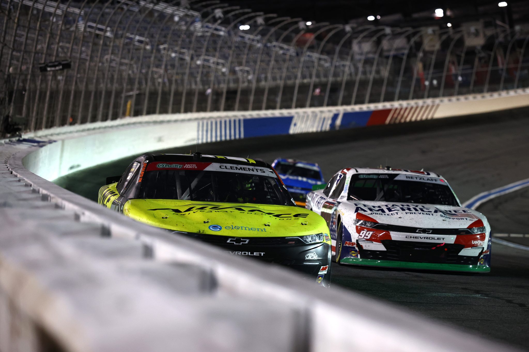 CONCORD, NORTH CAROLINA - OCTOBER 11: Jeremy Clements, driver of the #51 Alliance Driveaway Solutions Chevrolet, and Parker Retzlaff, driver of the #99 Fentanyl Free America Chevrolet, race during the NASCAR O'Reilly Auto Parts Series Blue Cross NC 300 at Charlotte Motor Speedway on October 11, 2026 in Concord, North Carolina. (Photo by Jared C. Tilton/Getty Images) | Getty Images