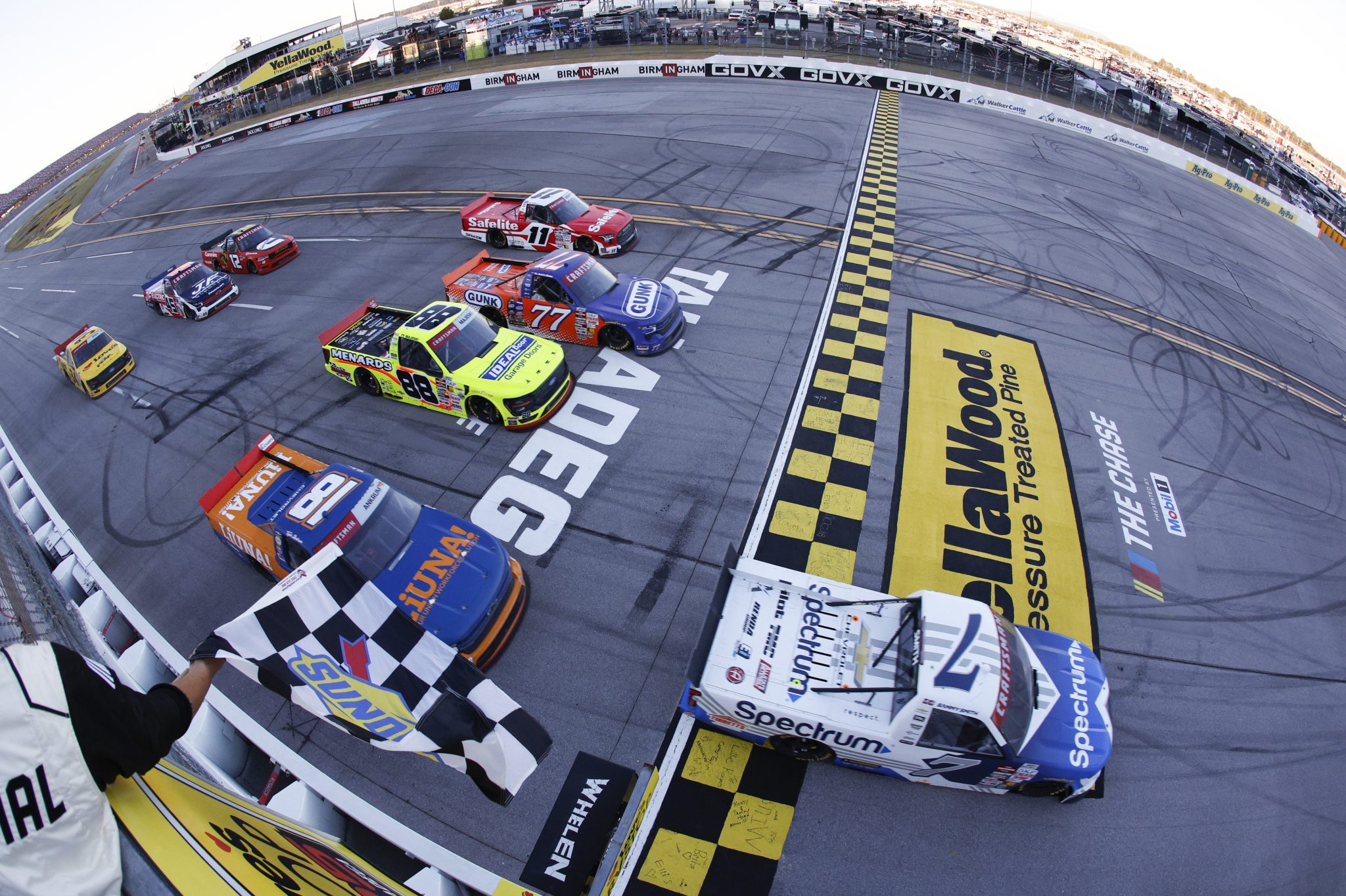 TALLADEGA, ALABAMA - OCTOBER 23: Sammy Smith, driver of the #7 Spectrum Chevrolet, takes the checkered flag to win the NASCAR Craftsman Truck Series Love's RV Stop 225 at Talladega Superspeedway on October 23, 2026 in Talladega, Alabama. (Photo by Sean Gardner/Getty Images) | Getty Images