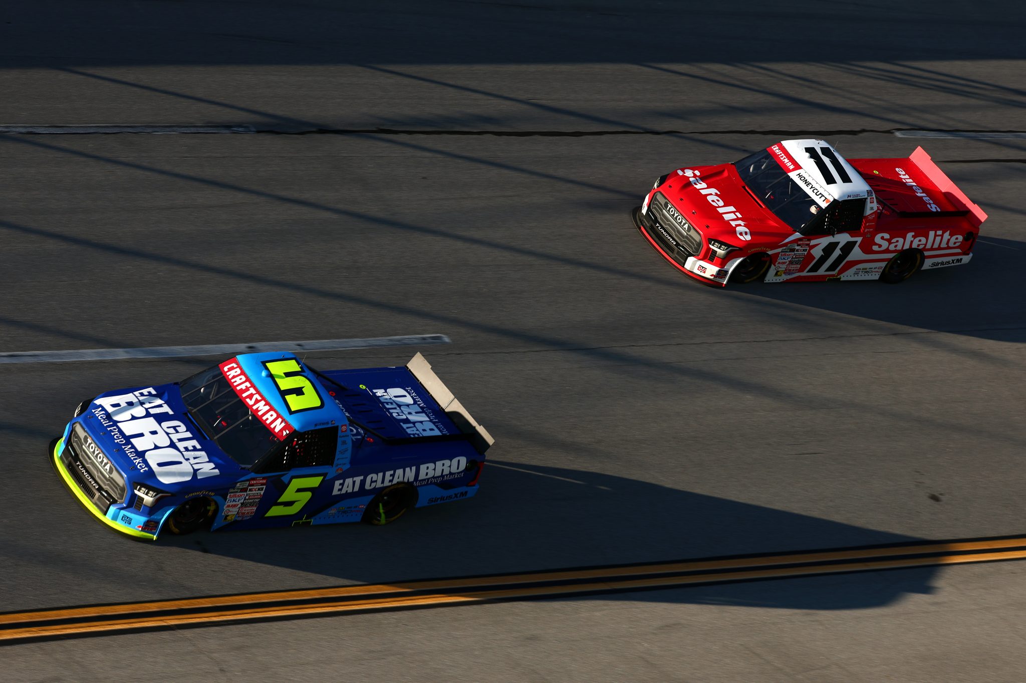 TALLADEGA, ALABAMA - OCTOBER 23: Thomas Annunziata, driver of the #5 Eat Clean Bro Toyota, and Kaden Honeycutt, driver of the #11 Safelite Toyota, race during the NASCAR Craftsman Truck Series Love's RV Stop 225 at Talladega Superspeedway on October 23, 2026 in Talladega, Alabama. (Photo by Karl Anderson/Getty Images) | Getty Images