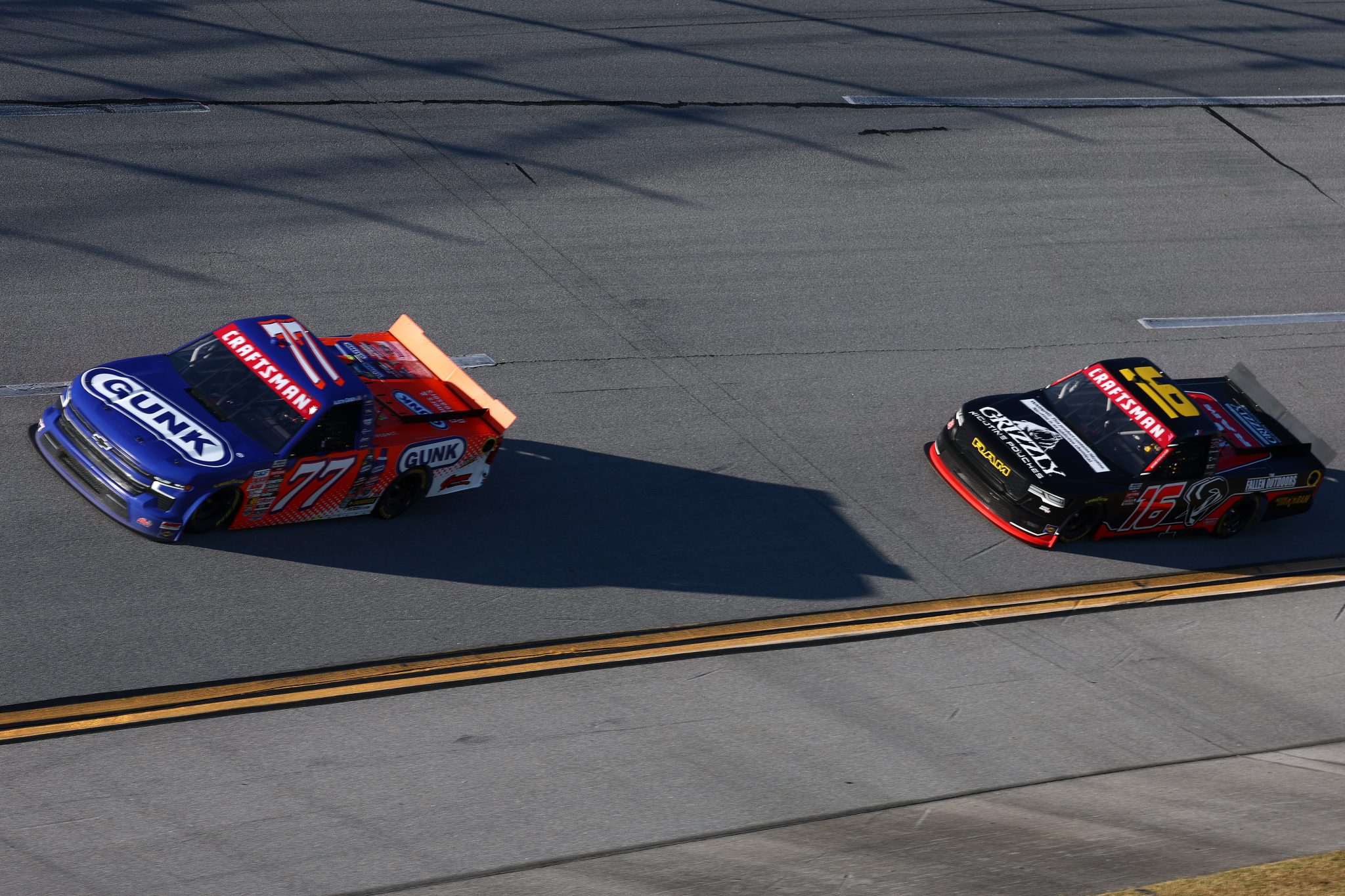 TALLADEGA, ALABAMA - OCTOBER 23: Austin Green, driver of the #77 Gunk Chevrolet, and Justin Haley, driver of the #16 Grizzly Nicotine Pouches RAM, race during the NASCAR Craftsman Truck Series Love's RV Stop 225 at Talladega Superspeedway on October 23, 2026 in Talladega, Alabama. (Photo by Karl Anderson/Getty Images) | Getty Images