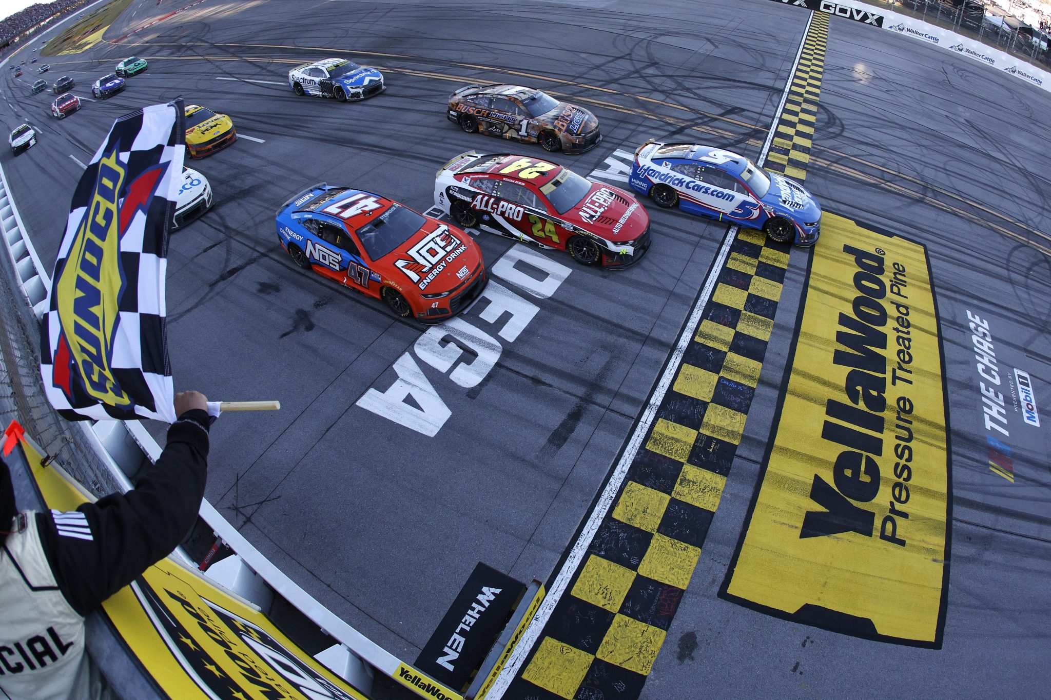 TALLADEGA, ALABAMA - OCTOBER 25: Kyle Larson, driver of the #5 HendrickCars.com Chevrolet, takes the checkered flag to win the NASCAR Cup Series YellaWood 500 at Talladega Superspeedway on October 25, 2026 in Talladega, Alabama. (Photo by Sean Gardner/Getty Images) | Getty Images