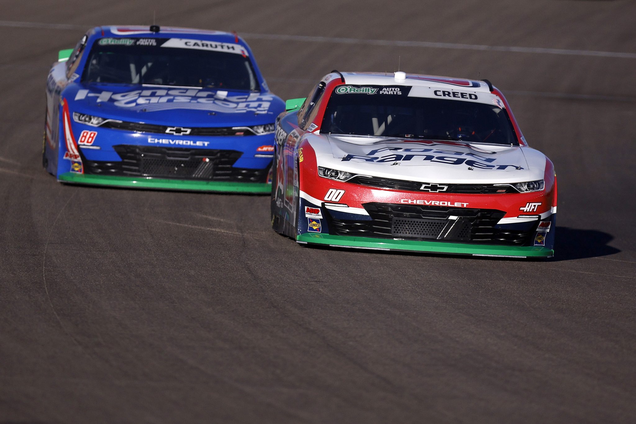 LAS VEGAS, NEVADA - OCTOBER 03: Sheldon Creed, driver of the #00 Road Ranger Chevrolet, and Rajah Caruth, driver of the #88 HendrickCars.com Chevrolet, race during the NASCAR O'Reilly Auto Parts Series Focused Health 302 at Las Vegas Motor Speedway on October 03, 2026 in Las Vegas, Nevada. (Photo by Sean Gardner/Getty Images) | Getty Images