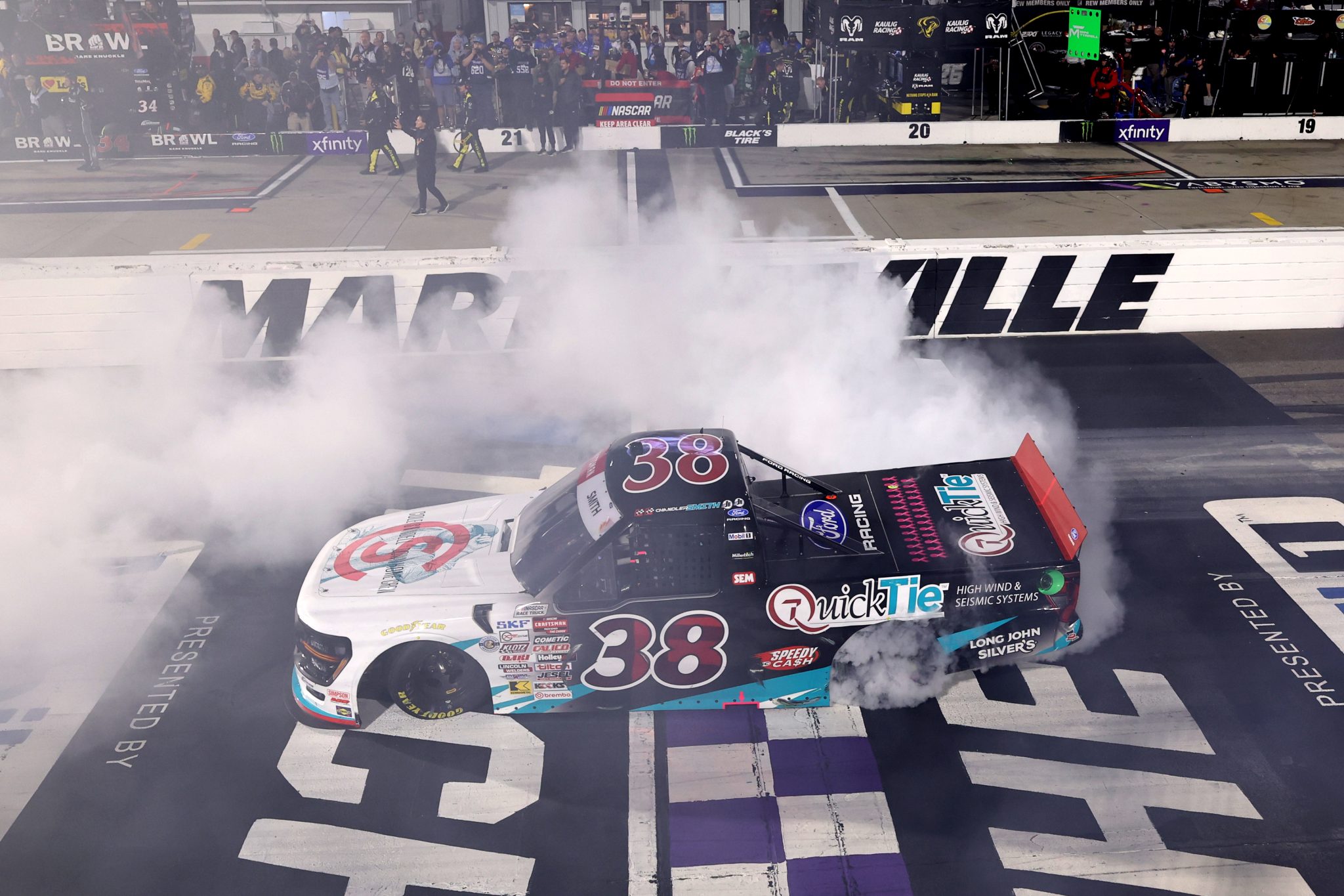 MARTINSVILLE, VIRGINIA - OCTOBER 30: Chandler Smith, driver of the #38 QuickTie/Cole Swindell Ford, celebrates with a burnout after winning the NASCAR Craftsman Truck Series Black's Tire 200 presented by Down East Heating & Air Conditioning at Martinsville Speedway on October 30, 2026 in Martinsville, Virginia. (Photo by David Jensen/Getty Images) | Getty Images