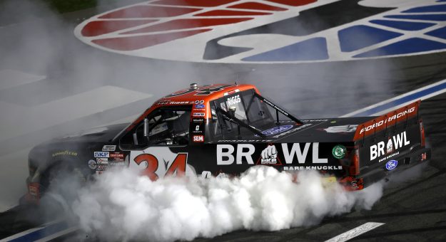 CONCORD, NORTH CAROLINA - OCTOBER 09: Layne Riggs, driver of the #34 BKB Bare Knuckle Boxing Ford, celebrates with a burnout after winning the NASCAR Craftsman Truck Series Ecosave 200 at Charlotte Motor Speedway on October 09, 2026 in Concord, North Carolina. (Photo by Jared C. Tilton/Getty Images) | Getty Images