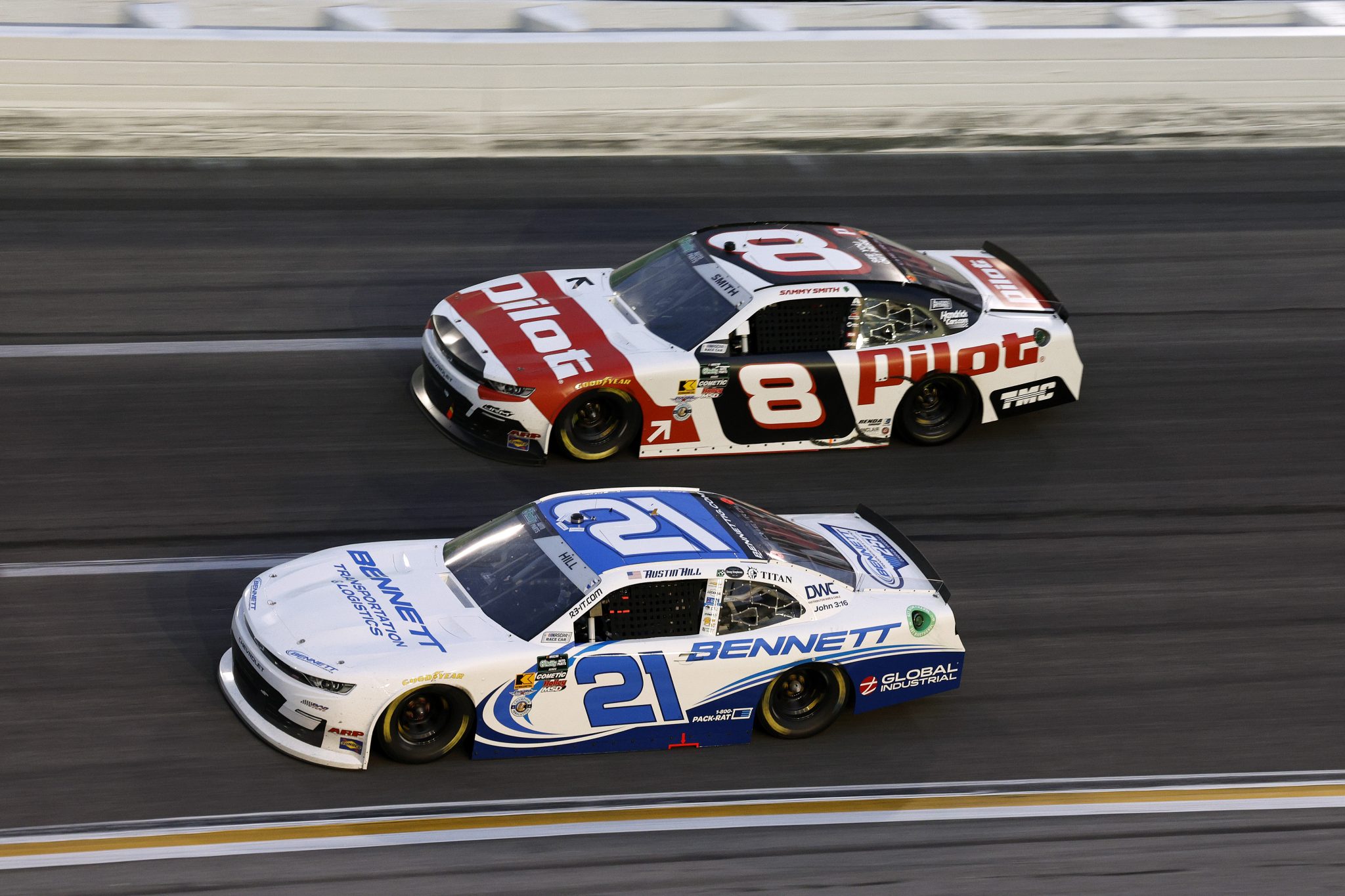 HAMPTON, GEORGIA - FEBRUARY 21: Austin Hill, driver of the #21 Bennett Transportation Chevrolet, and Sammy Smith, driver of the #8 Pilot Chevrolet, race during the NASCAR O'Reilly Auto Parts Series Bennett Transportation & Logistics 250 at Echo Park Speedway on February 21, 2026 in Hampton, Georgia. (Photo by Sean Gardner/Getty Images) | Getty Images