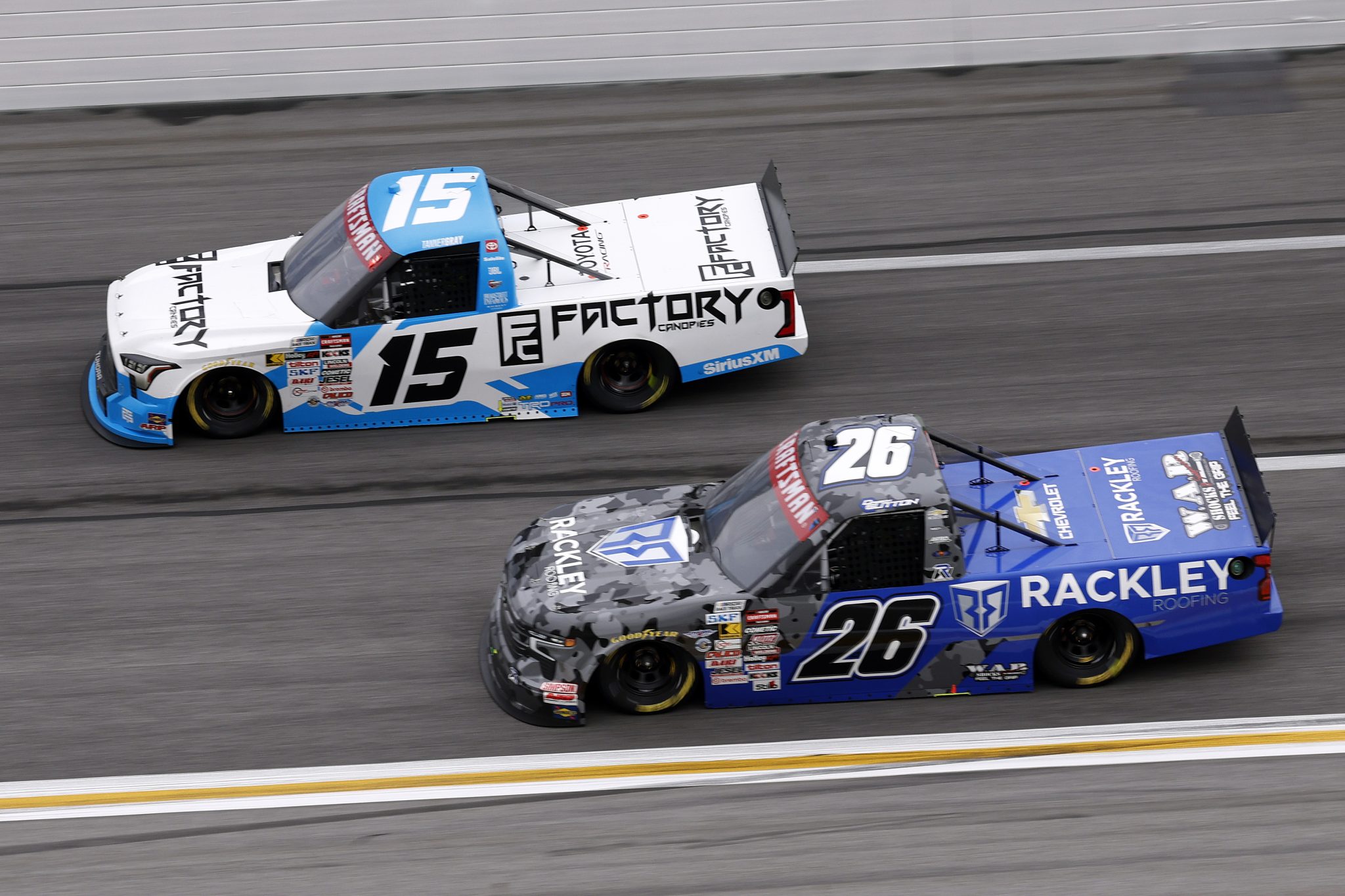 HAMPTON, GEORGIA - FEBRUARY 21: Tanner Gray, driver of the #15 Factory Canopies Toyota, and Dawson Sutton, driver of the #26 WAR Shocks/Rackley Roofing Chevrolet, race during the NASCAR Craftsman Truck Series Fr8 Racing 208 at Echo Park Speedway on February 21, 2026 in Hampton, Georgia. (Photo by Sean Gardner/Getty Images) | Getty Images