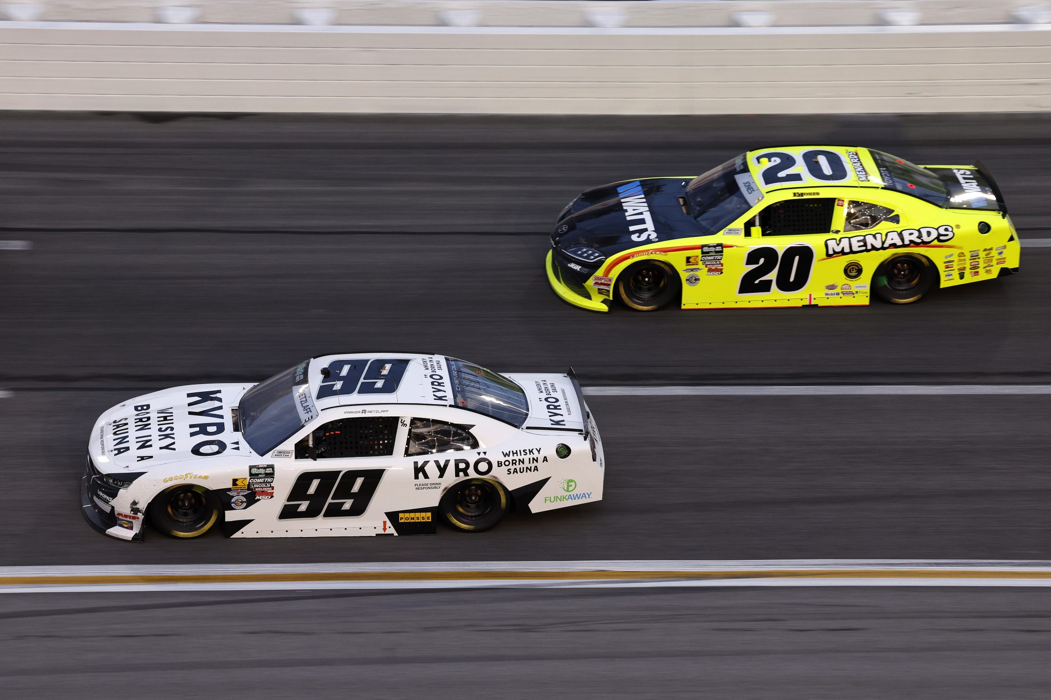 HAMPTON, GEORGIA - FEBRUARY 21: Parker Retzlaff, driver of the #99 KYRO Whisky Chevrolet, and Brandon Jones, driver of the #20 Menards/Watts Toyota, race during the NASCAR O'Reilly Auto Parts Series Bennett Transportation & Logistics 250 at Echo Park Speedway on February 21, 2026 in Hampton, Georgia. (Photo by Sean Gardner/Getty Images) | Getty Images
