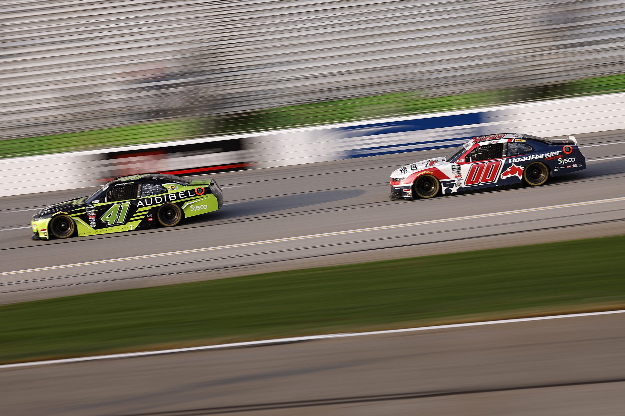 HAMPTON, GEORGIA - FEBRUARY 21: Sam Mayer, driver of the #41 Audibel Chevrolet, and Sheldon Creed, driver of the #00 Road Ranger Chevrolet, race during the NASCAR O'Reilly Auto Parts Series Bennett Transportation & Logistics 250 at Echo Park Speedway on February 21, 2026 in Hampton, Georgia. (Photo by Sean Gardner/Getty Images) | Getty Images