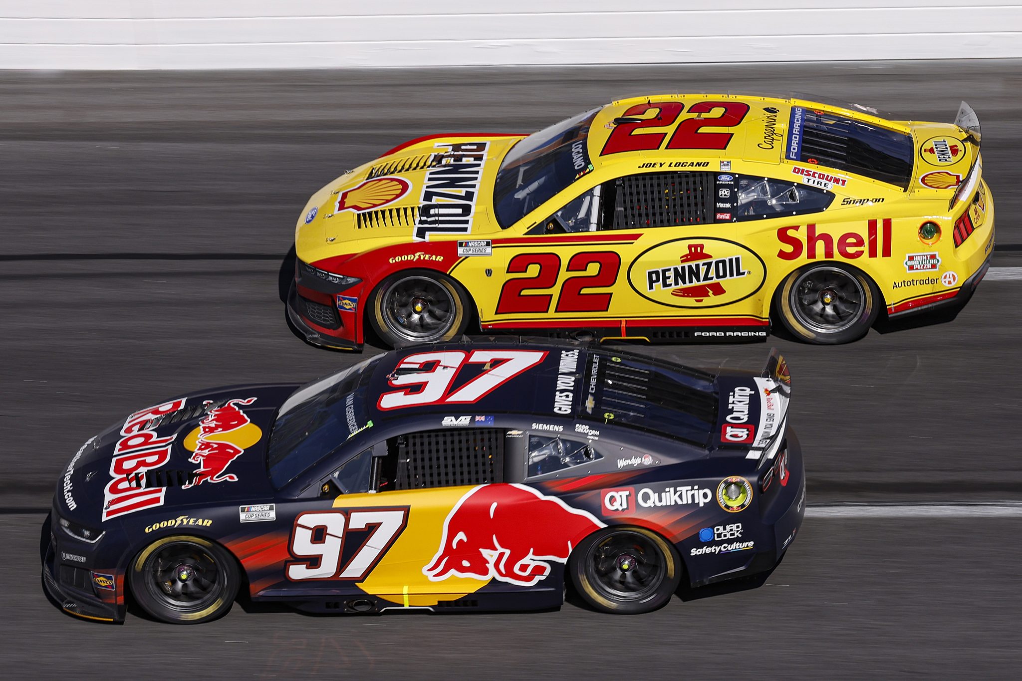 HAMPTON, GEORGIA - FEBRUARY 22: Shane Van Gisbergen, driver of the #97 Red Bull Chevrolet, and Joey Logano, driver of the #22 Shell Pennzoil Ford, race during the NASCAR Cup Series Autotrader 400 at Echo Park Speedway on February 22, 2026 in Hampton, Georgia. (Photo by Sean Gardner/Getty Images) | Getty Images