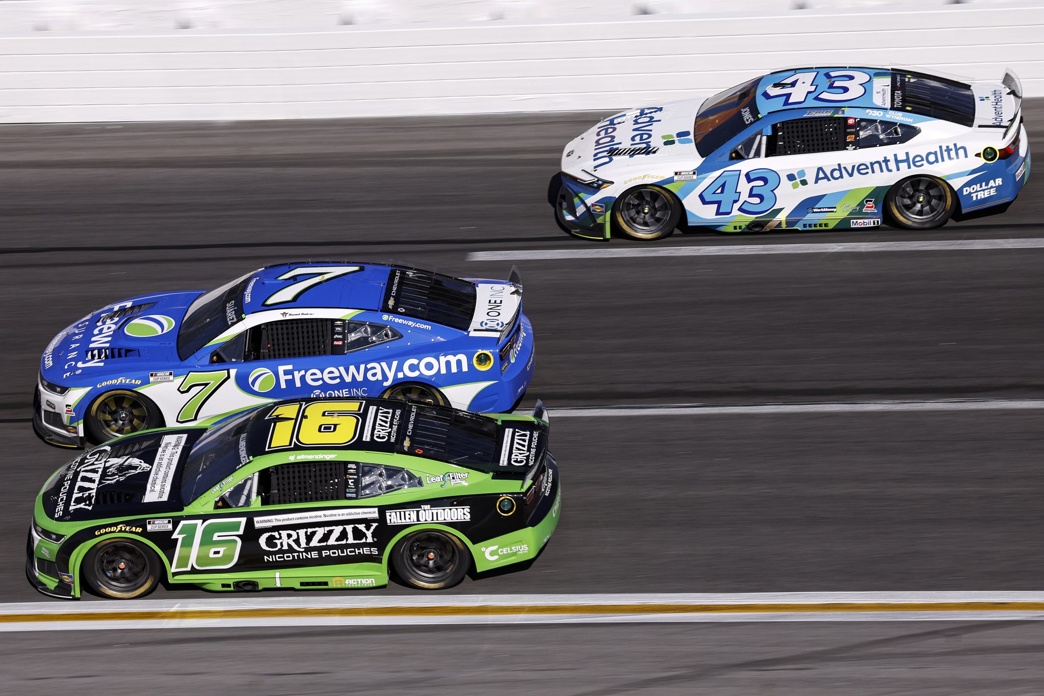HAMPTON, GEORGIA - FEBRUARY 22: AJ Allmendinger, driver of the #16 Grizzly Nicotine Pouches Chevrolet, Daniel Suarez, driver of the #7 Freeway Insurance Chevrolet, and Erik Jones, driver of the #43 AdventHealth Toyota, race during the NASCAR Cup Series Autotrader 400 at Echo Park Speedway on February 22, 2026 in Hampton, Georgia. (Photo by Sean Gardner/Getty Images) | Getty Images