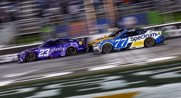 HAMPTON, GEORGIA - FEBRUARY 22: Bubba Wallace, driver of the #23 Xfinity Toyota, Christopher Bell, driver of the #20 DEWALT Toyota, and Carson Hocevar, driver of the #77 Spectrum Chevrolet, race during the NASCAR Cup Series Autotrader 400 at Echo Park Speedway on February 22, 2026 in Hampton, Georgia. (Photo by Sean Gardner/Getty Images) | Getty Images