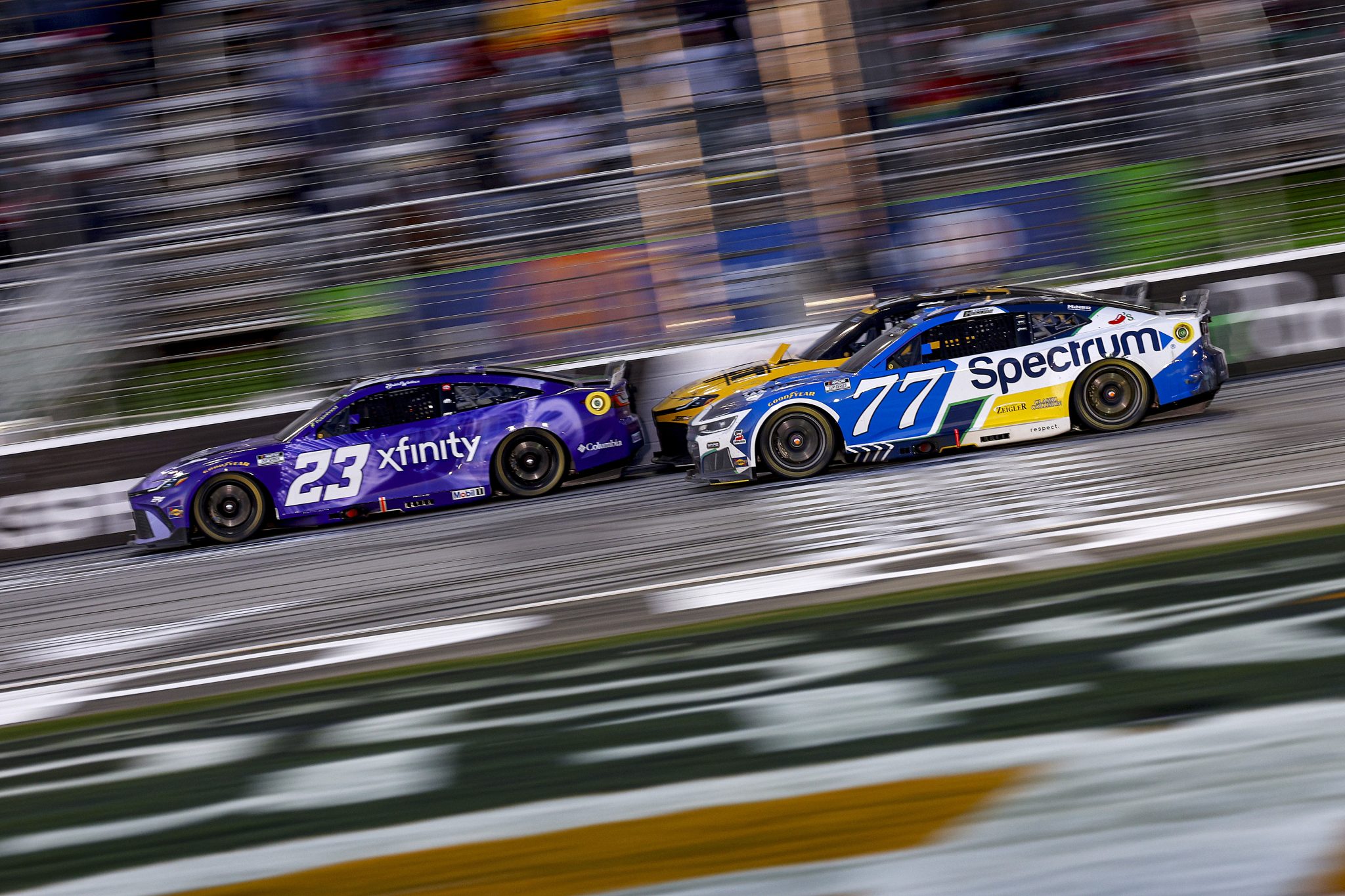 HAMPTON, GEORGIA - FEBRUARY 22: Bubba Wallace, driver of the #23 Xfinity Toyota, Christopher Bell, driver of the #20 DEWALT Toyota, and Carson Hocevar, driver of the #77 Spectrum Chevrolet, race during the NASCAR Cup Series Autotrader 400 at Echo Park Speedway on February 22, 2026 in Hampton, Georgia. (Photo by Sean Gardner/Getty Images) | Getty Images