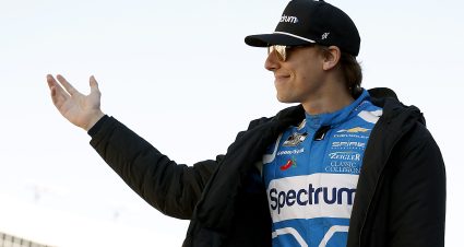 HAMPTON, GEORGIA - FEBRUARY 22: Carson Hocevar, driver of the #77 Spectrum Chevrolet, waves to fans as he walks onstage during driver intros prior to the NASCAR Cup Series Autotrader 400 at Echo Park Speedway on February 22, 2026 in Hampton, Georgia. (Photo by Sean Gardner/Getty Images) | Getty Images