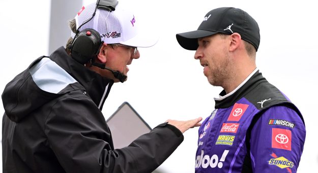 MADISON, ILLINOIS - JUNE 01: Denny Hamlin, driver of the #11 Yahoo! Toyota, and crew chief Christopher Gabehart talk on the grid during qualifying for the NASCAR Cup Series Enjoy Illinois 300 at WWT Raceway on June 01, 2024 in Madison, Illinois. (Photo by Logan Riely/Getty Images) | Getty Images