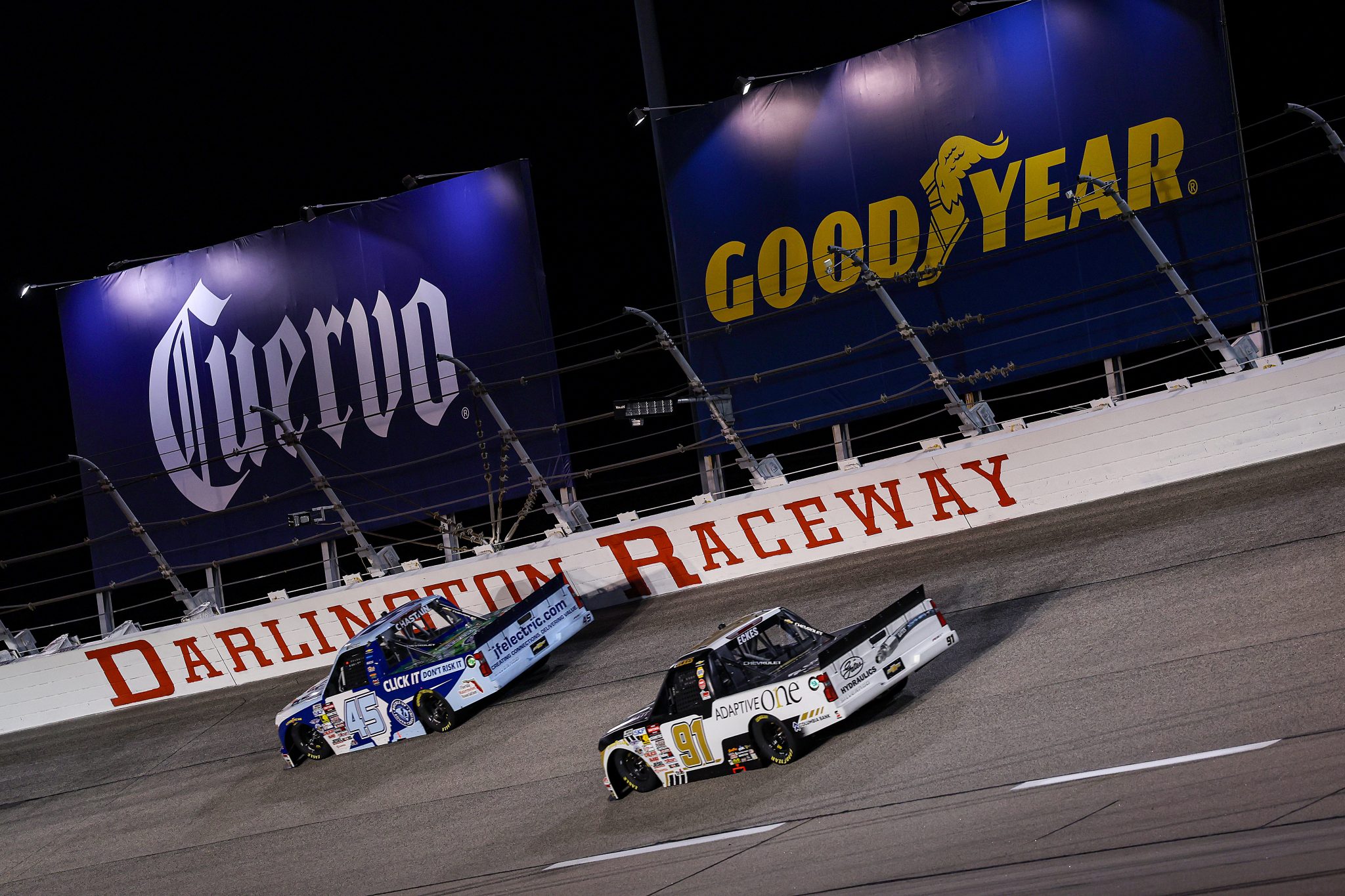 DARLINGTON, SOUTH CAROLINA - MARCH 20: Ross Chastain, driver of the #45 Buckle Up South Carolina Chevrolet, and Christian Eckes, driver of the #91 Adaptive One Calipers Chevrolet, race during the NASCAR Craftsman Truck Series Buckle Up South Carolina 200 at Darlington Raceway on March 20, 2026 in Darlington, South Carolina. (Photo by David Jensen/Getty Images) | Getty Images