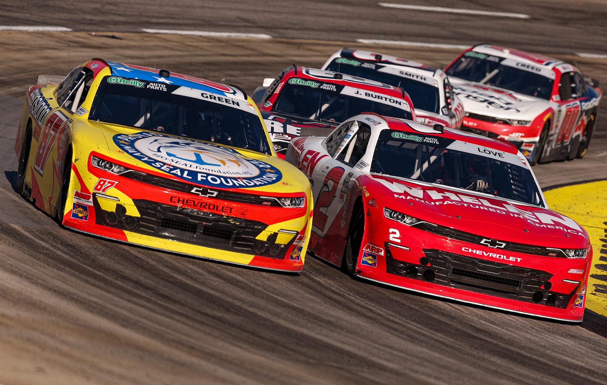 MARTINSVILLE, VIRGINIA - MARCH 28: Jesse Love, driver of the #2 Whelen Chevrolet, and Austin Green, driver of the #87 3Dimensional.com Chevrolet, race during the NASCAR O'Reilly Auto Parts Series NFPA 250 at Martinsville Speedway on March 28, 2026 in Martinsville, Virginia. (Photo by David Jensen/Getty Images) | Getty Images