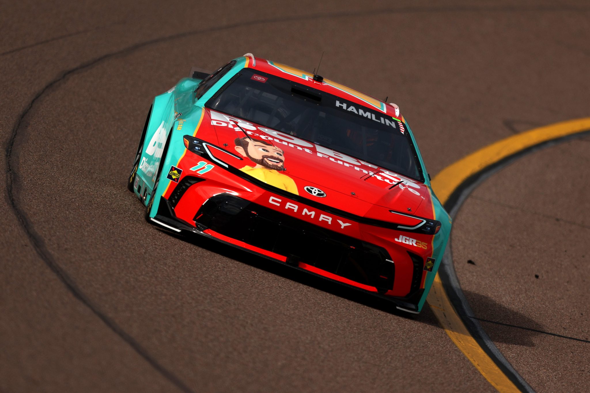 AVONDALE, ARIZONA - MARCH 07: Denny Hamlin, driver of the #11 Bob's Discount Furniture Toyota, drives during practice for the NASCAR Cup Series Straight Talk Wireless 500 at Phoenix Raceway on March 07, 2026 in Avondale, Arizona. (Photo by Meg Oliphant/Getty Images) | Getty Images