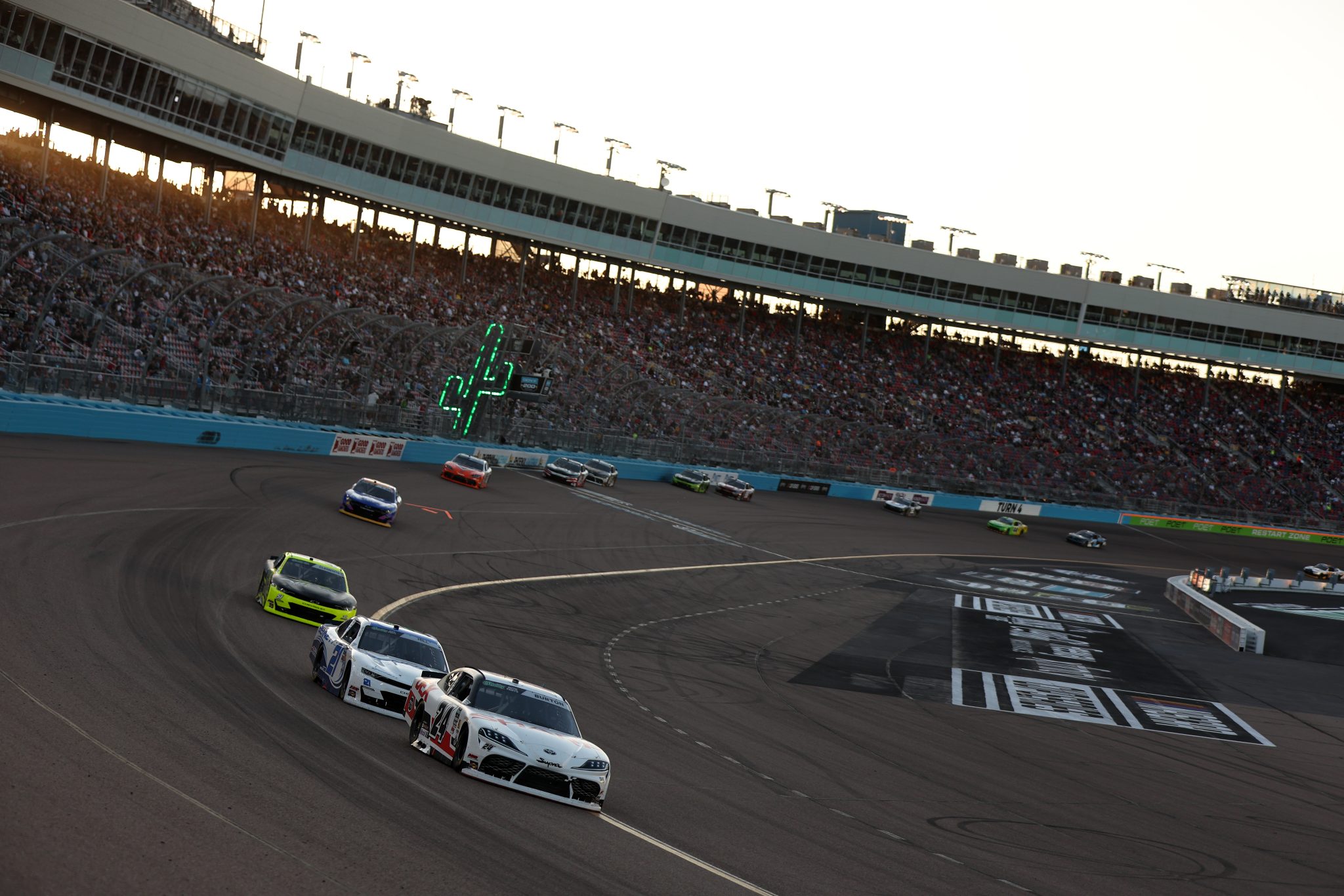 AVONDALE, ARIZONA - MARCH 07: Harrison Burton, driver of the #24 DEX/Sharp Toyota, and Austin Hill, driver of the #21 Bennett Transportation Chevrolet, race during the NASCAR O'Reilly Auto Parts Series GOVX 200 at Phoenix Raceway on March 07, 2026 in Avondale, Arizona. (Photo by Meg Oliphant/Getty Images) | Getty Images