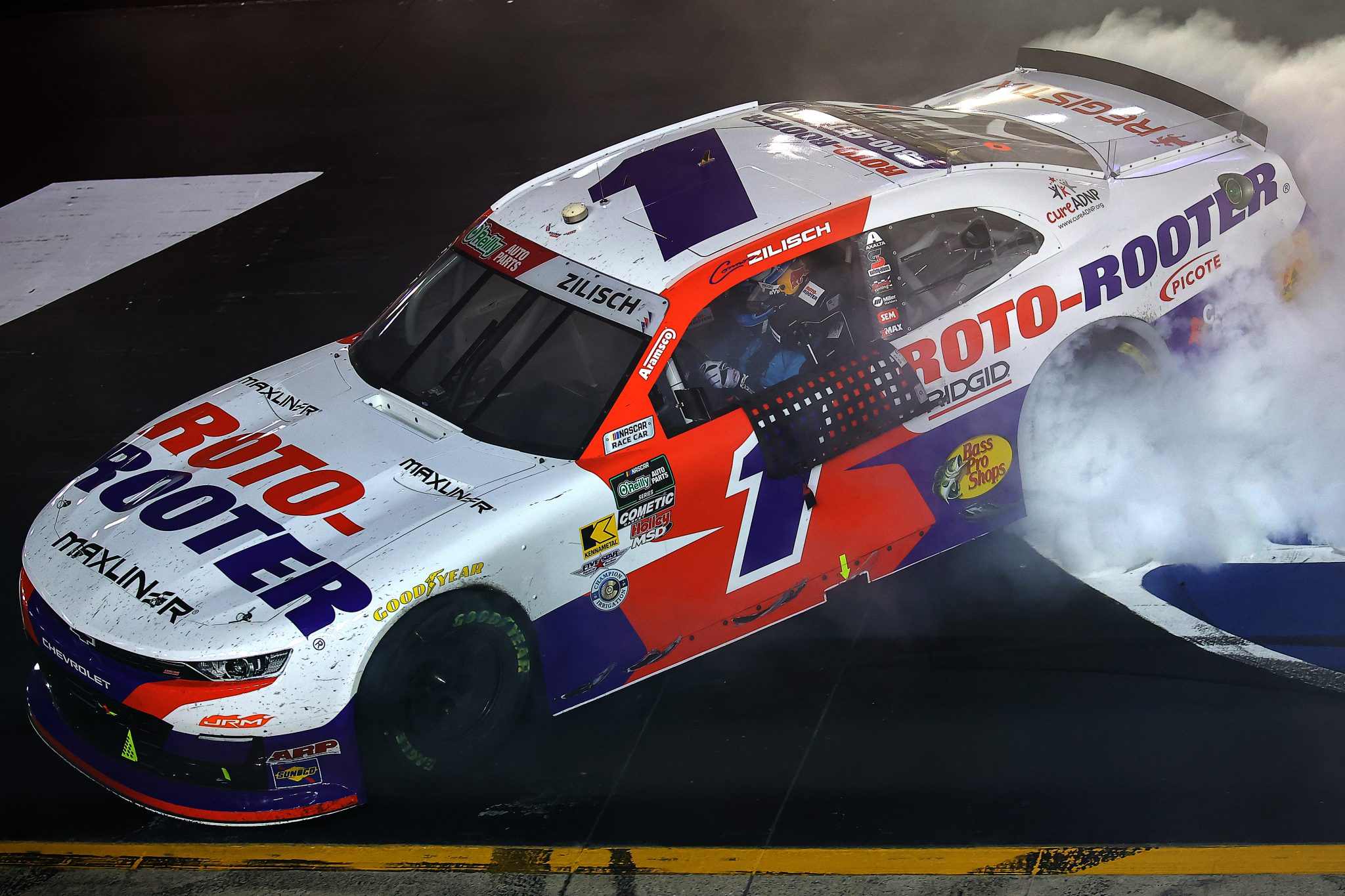 BRISTOL, TENNESSEE - APRIL 11: Connor Zilisch, driver of the #1 Roto-Rooter Chevrolet, celebrates with a burnout after winning the NASCAR O'Reilly Auto Parts Series Suburban Propane 300 at Bristol Motor Speedway on April 11, 2026 in Bristol, Tennessee. (Photo by Jonathan Bachman/Getty Images) | Getty Images