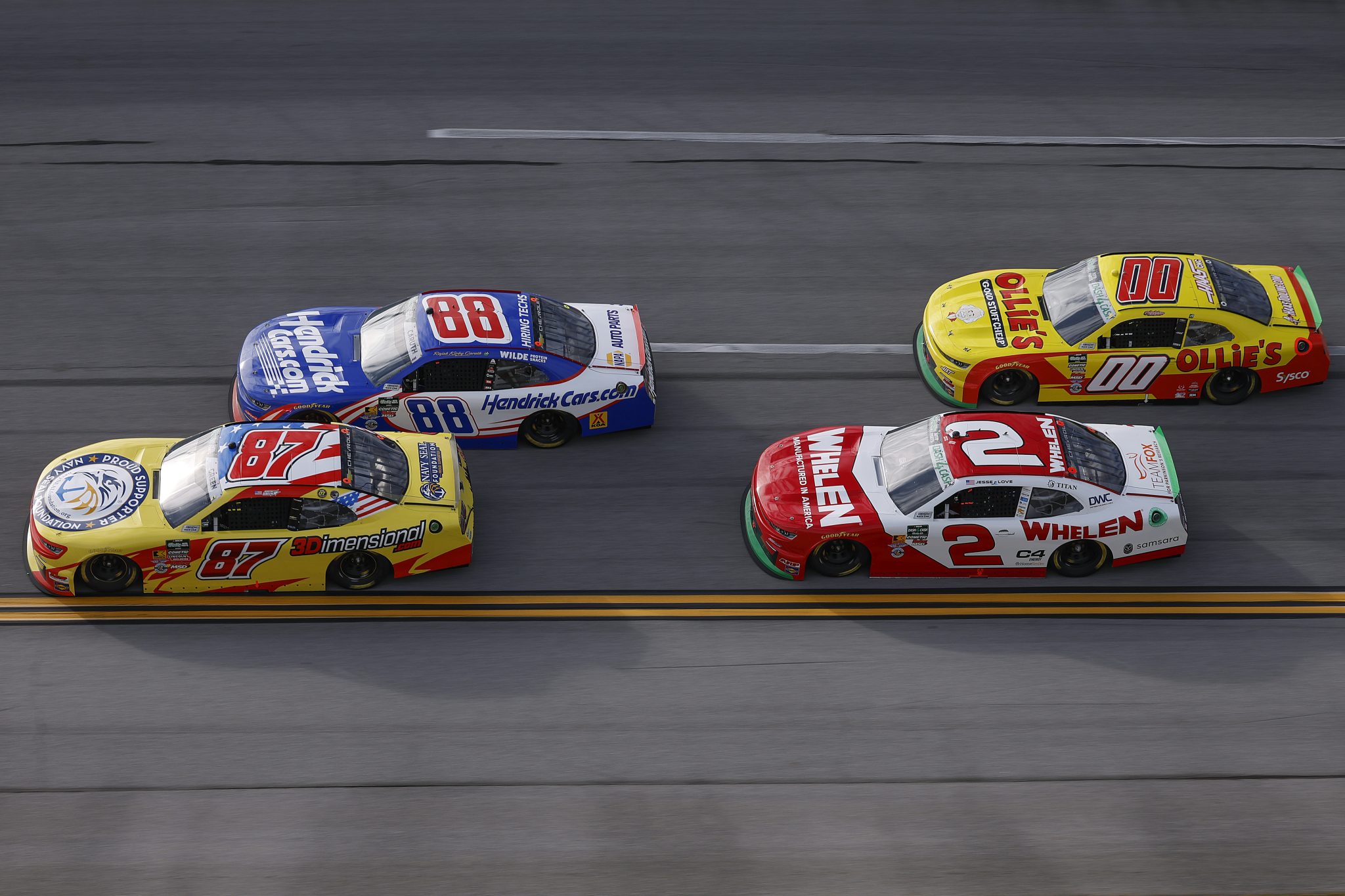 TALLADEGA, ALABAMA - APRIL 25: Austin Green, driver of the #87 3Dimensional.com Chevrolet, Rajah Caruth, driver of the #88 Hendrick Cars.com Chevrolet, Jesse Love, driver of the #2 Whelen Chevrolet, and Sheldon Creed, driver of the #00 Ollie's Chevrolet, race during the NASCAR O'Reilly Auto Parts Series Ag-Pro 300 at Talladega Superspeedway on April 25, 2026 in Talladega, Alabama. (Photo by Sean Gardner/Getty Images) | Getty Images