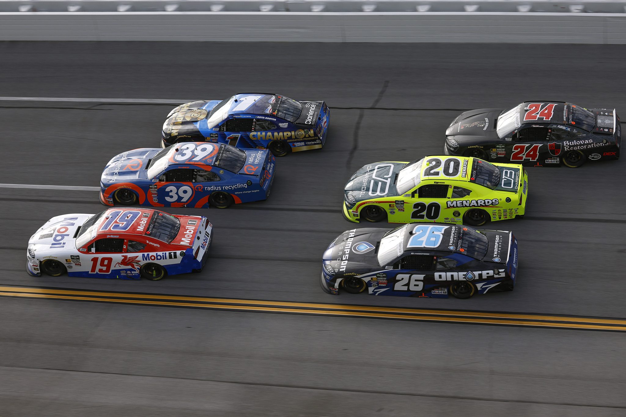 TALLADEGA, ALABAMA - APRIL 25: Brent Crews, driver of the #19 Mobil 1 Toyota, Ryan Sieg, driver of the #39 radius recycling Chevrolet, Carson Kvapil, driver of the #1 Champion Irrigation Products Chevrolet, Dean Thompson, driver of the #26 Thompson Pipe Group Toyota, Brandon Jones, driver of the #20 Menards/Charbroil Toyota, and Harrison Burton, driver of the #24 Jesse Gerhard Memorial Foundation Bulovas Restorations Toyota, race during the NASCAR O'Reilly Auto Parts Series Ag-Pro 300 at Talladega Superspeedway on April 25, 2026 in Talladega, Alabama. (Photo by Sean Gardner/Getty Images) | Getty Images