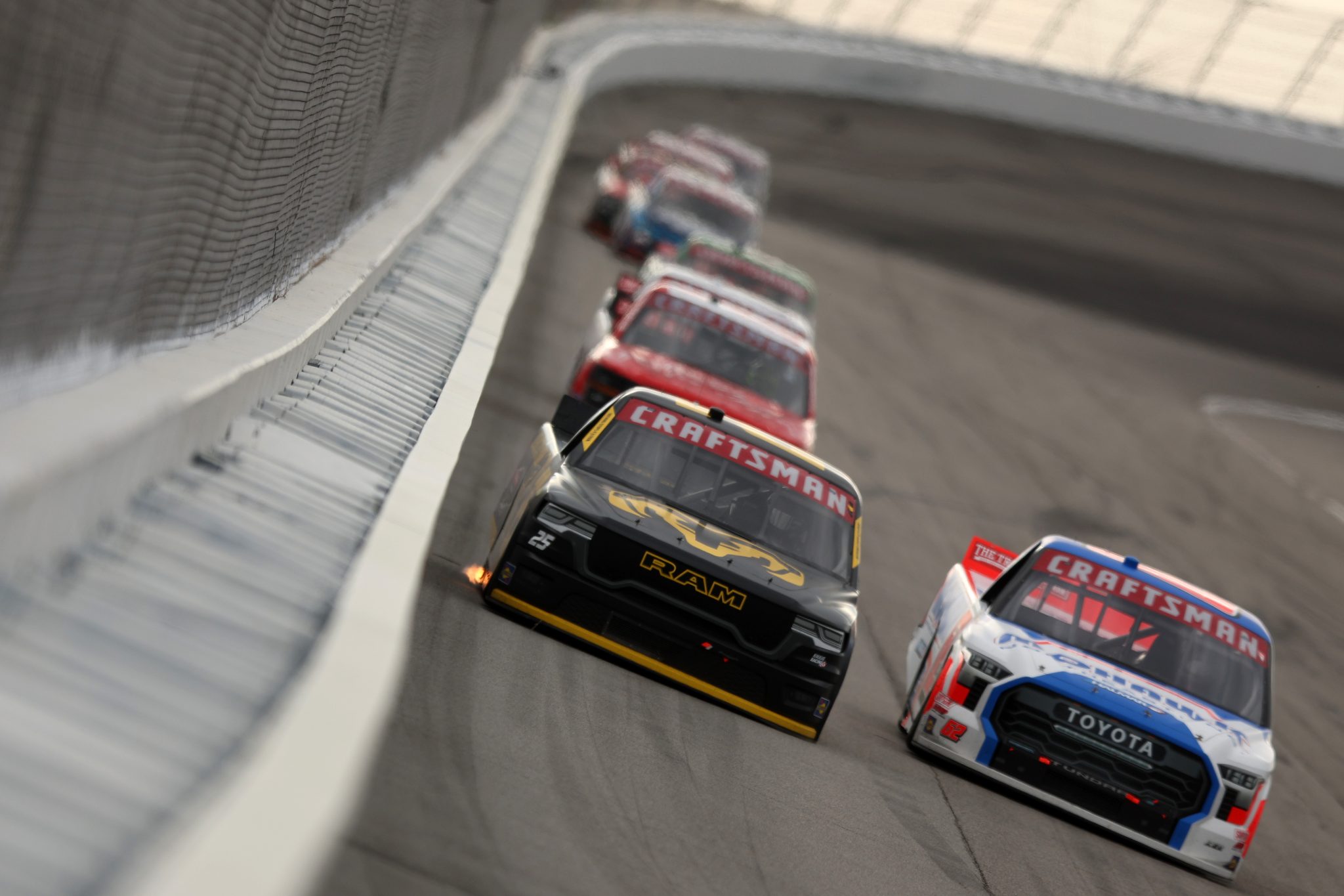 ROCKINGHAM, NORTH CAROLINA - APRIL 03: Ty Dillon, driver of the #25 Nothing Stops Ram RAM, and Michael Christopher Jr., driver of the #62 Mohawk Northeast Toyota, race during the NASCAR Craftsman Truck Series Black's Tire 200 at Rockingham Speedway on April 03, 2026 in Rockingham, North Carolina. (Photo by Meg Oliphant/Getty Images) | Getty Images