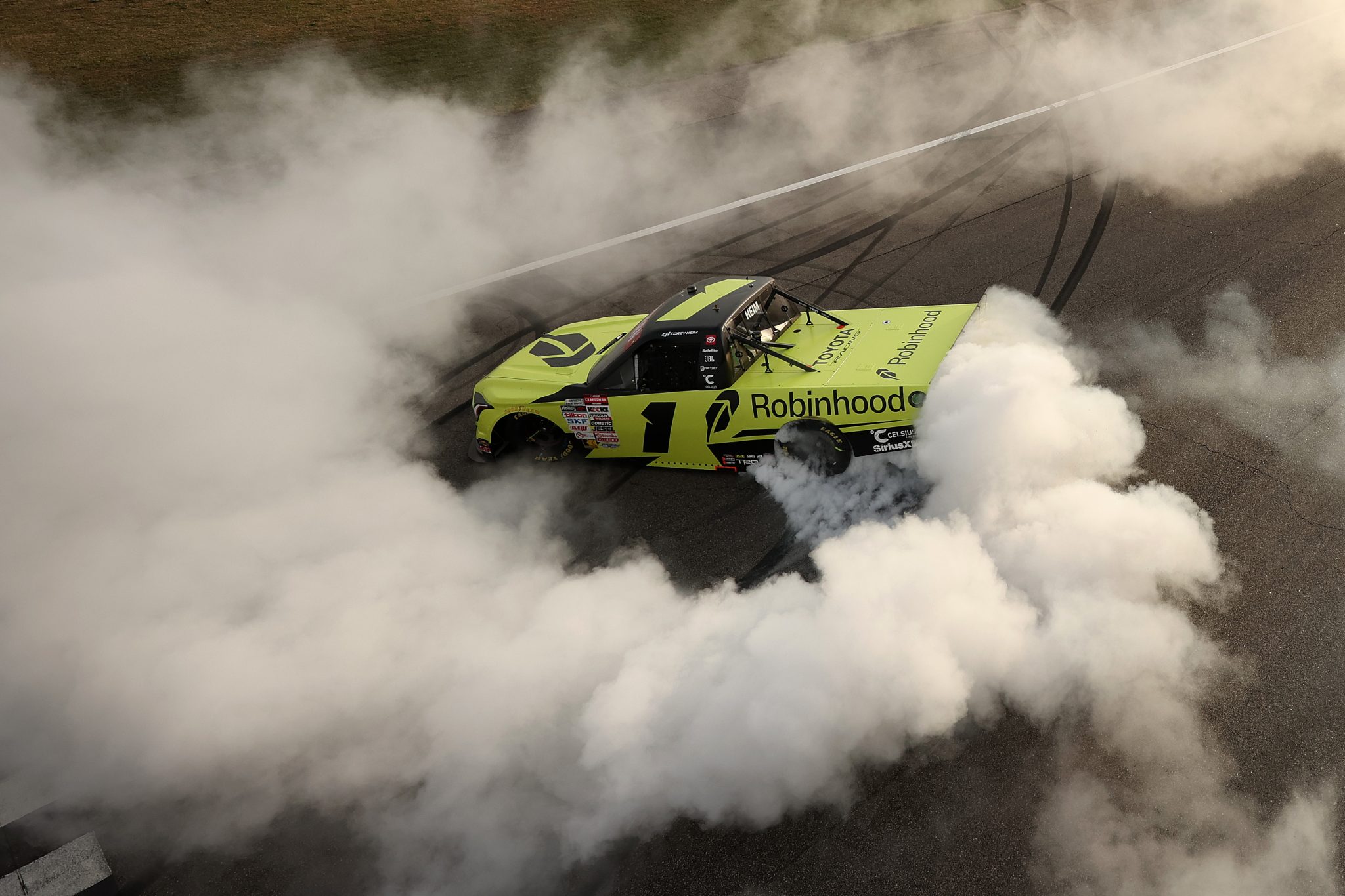 ROCKINGHAM, NORTH CAROLINA - APRIL 03: Corey Heim, driver of the #1 Robinhood Toyota, celebrates with a burnout after winning the NASCAR Craftsman Truck Series Black's Tire 200 at Rockingham Speedway on April 03, 2026 in Rockingham, North Carolina. (Photo by Meg Oliphant/Getty Images) | Getty Images