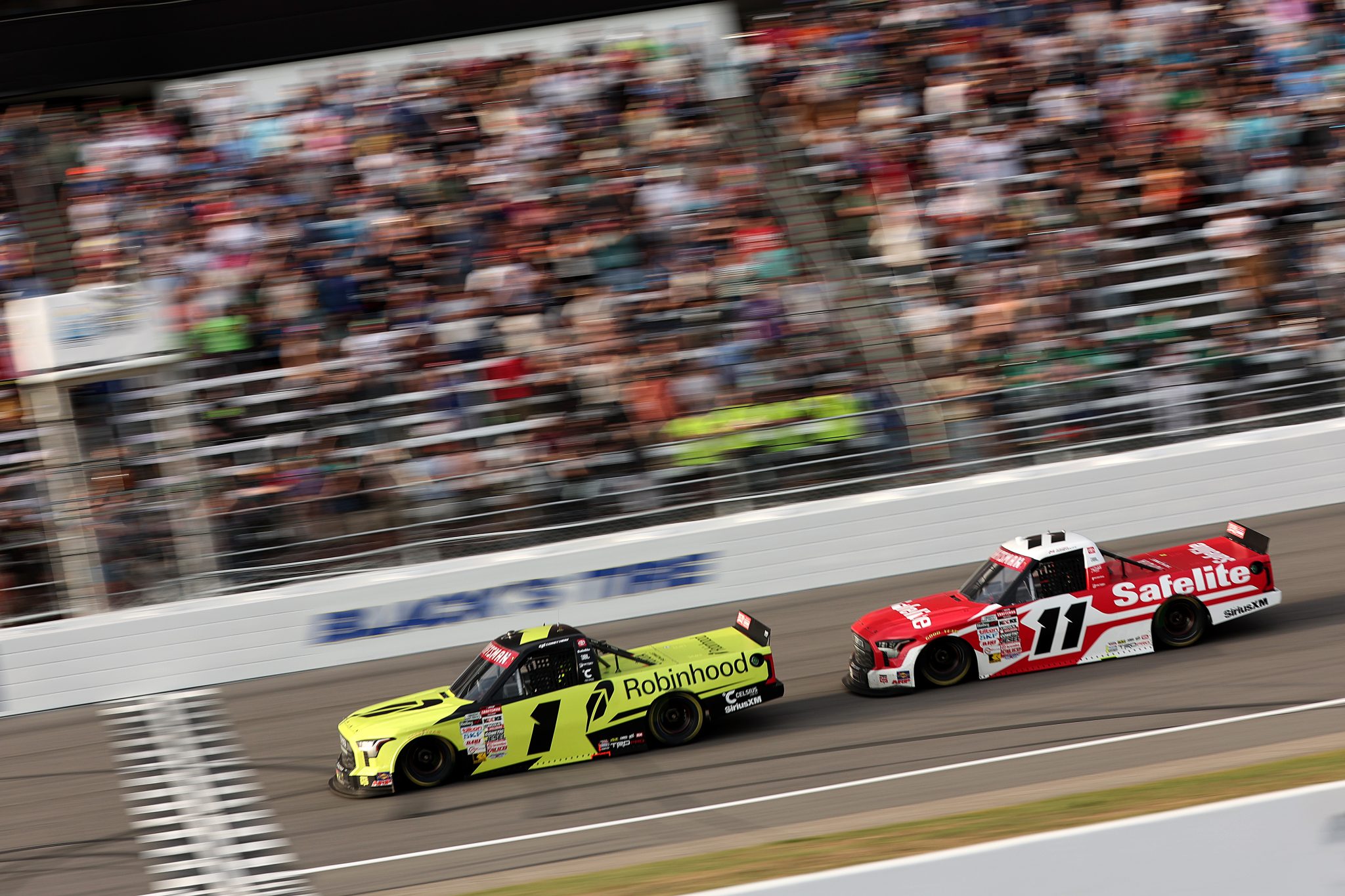 ROCKINGHAM, NORTH CAROLINA - APRIL 03: Corey Heim, driver of the #1 Robinhood Toyota, leads Kaden Honeycutt, driver of the #11 Safelite Toyota, to win the NASCAR Craftsman Truck Series Black's Tire 200 at Rockingham Speedway on April 03, 2026 in Rockingham, North Carolina. (Photo by James Gilbert/Getty Images) | Getty Images