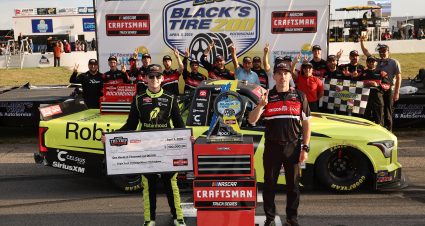 ROCKINGHAM, NORTH CAROLINA - APRIL 03: Corey Heim, driver of the #1 Robinhood Toyota, and crew chief Jerame Donley celebrate with the Triple Truck Challenge $100,000.00 check in victory lane after winning the the NASCAR Craftsman Truck Series Black's Tire 200 at Rockingham Speedway on April 03, 2026 in Rockingham, North Carolina. (Photo by James Gilbert/Getty Images) | Getty Images